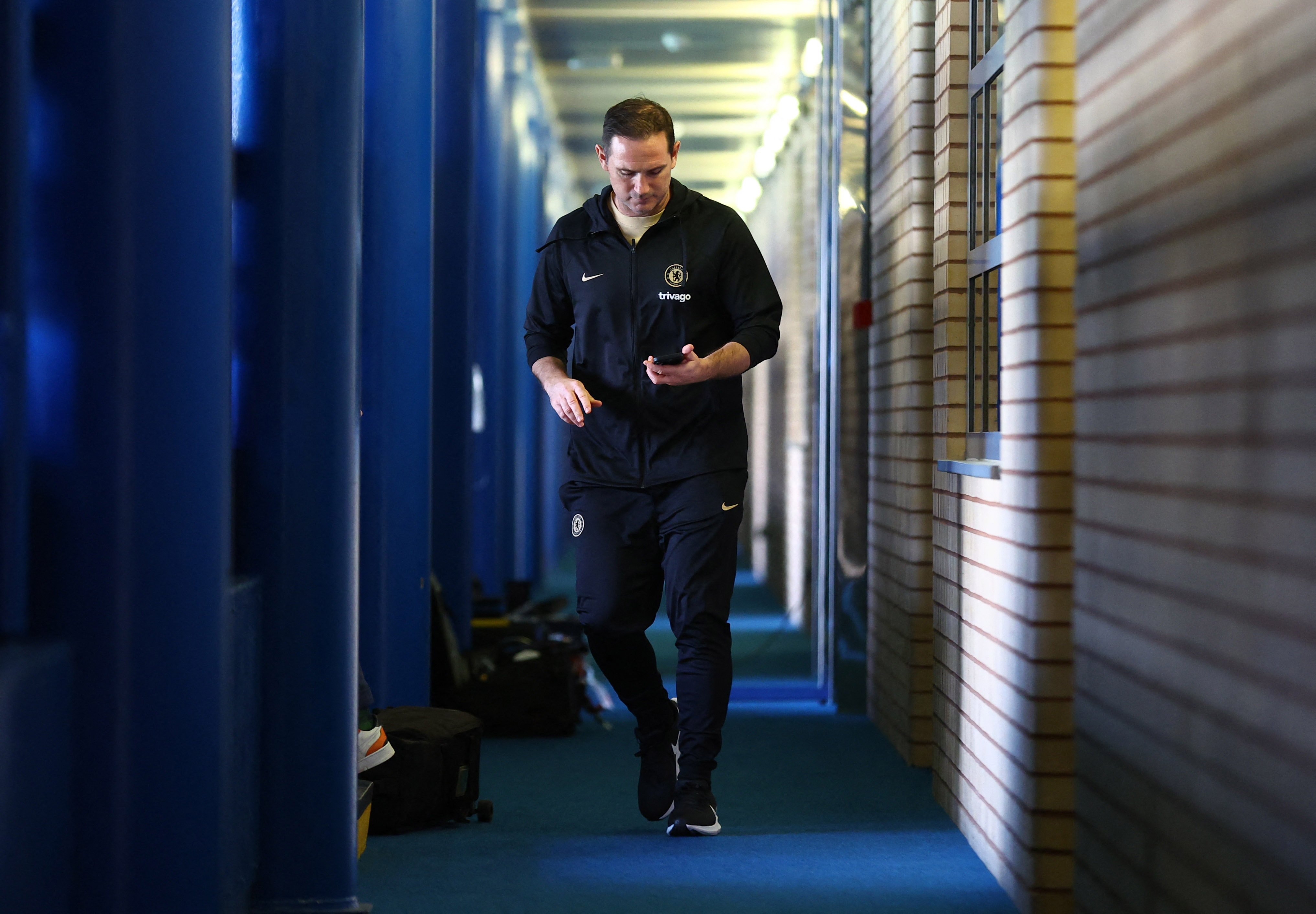 Chelsea manager Frank Lampard walks down a hall before a press conference