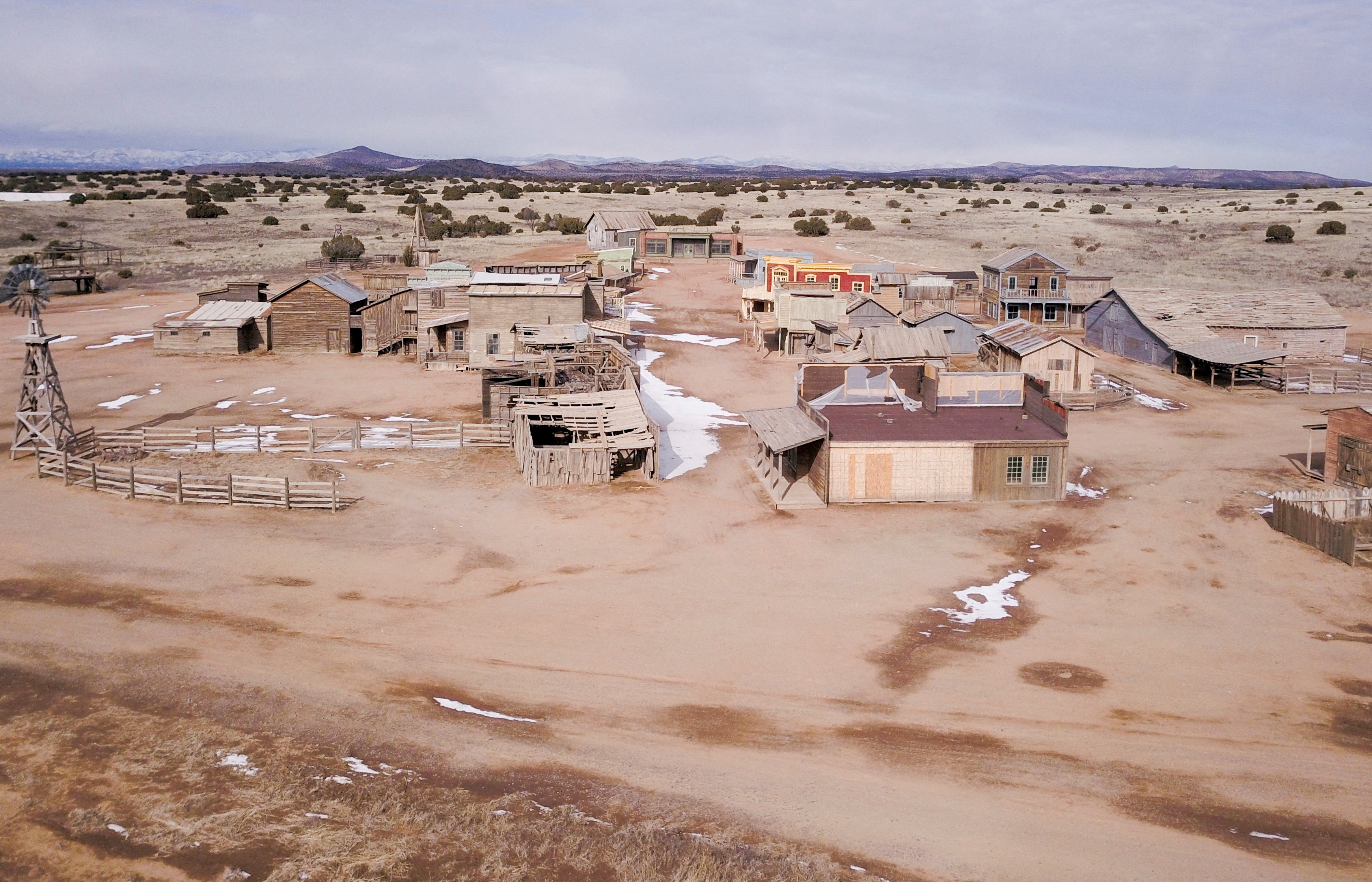 An aerial view of a desert film set, populated by small houses and structures