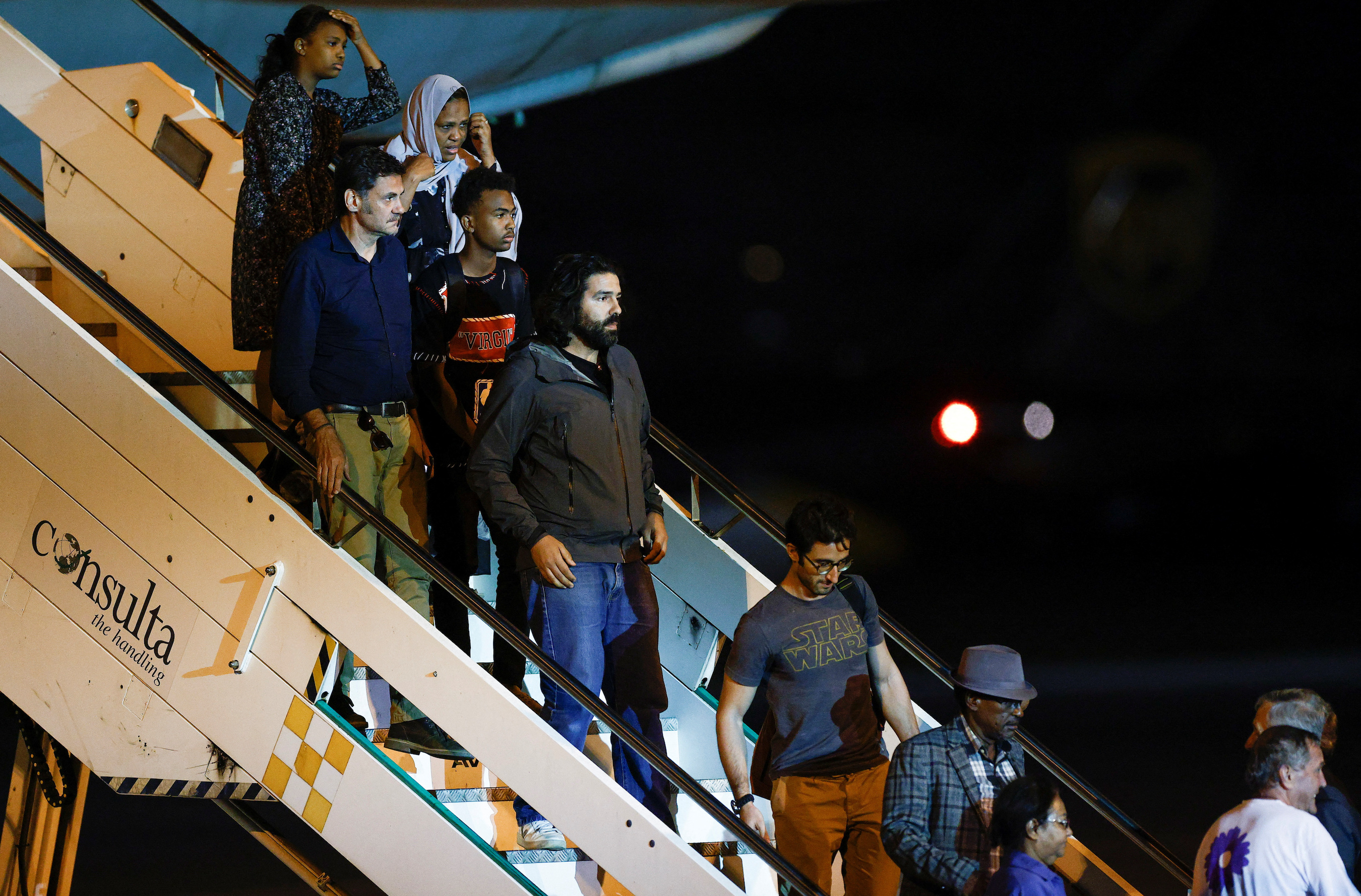 Evacuees from war-torn Sudan leave an Italian military plane upon their arrival at Ciampino airport near Rome, Italy.