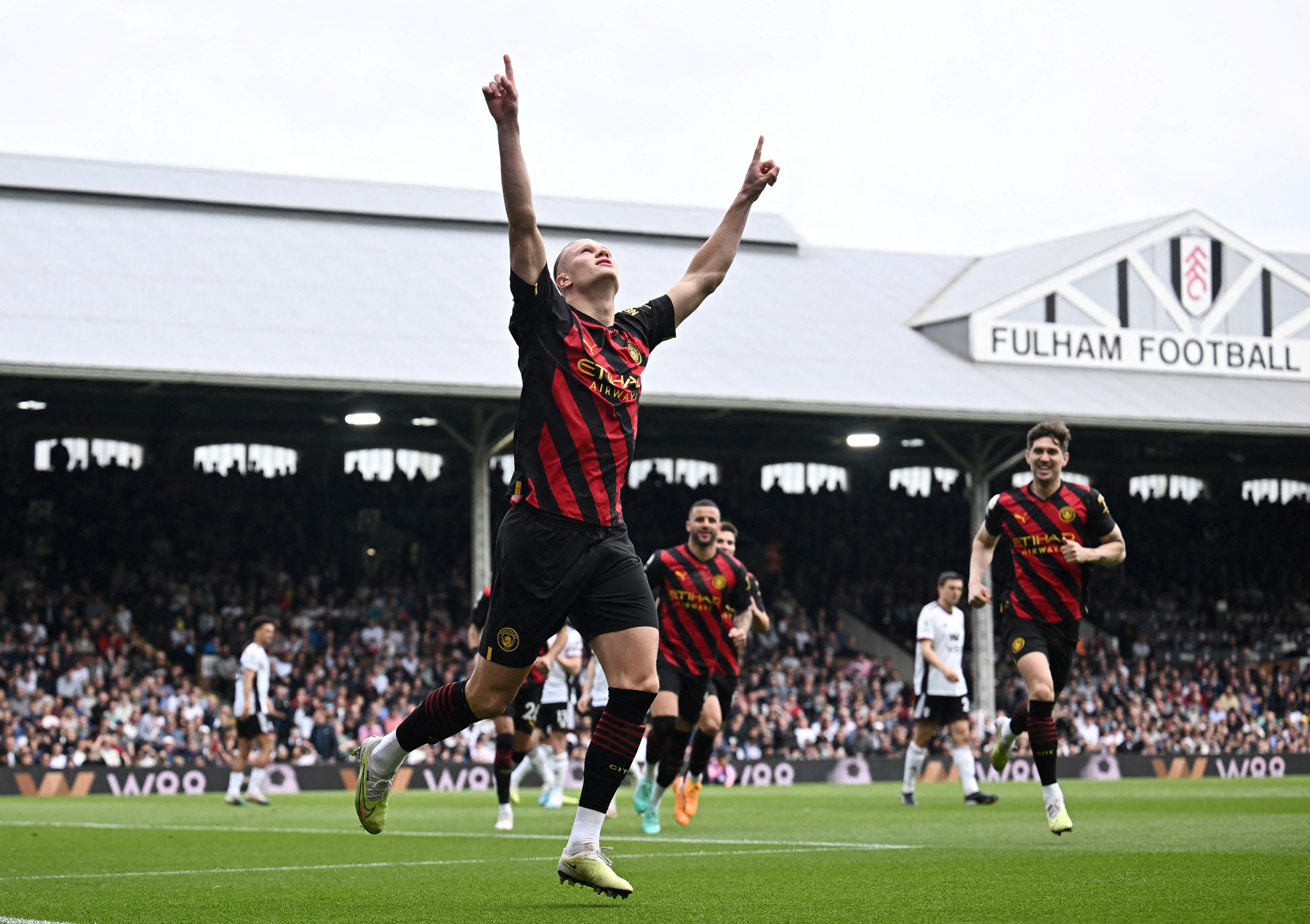 Haaland celebrates scoring Man chester City's first goal against Fulham at Craven Cottage