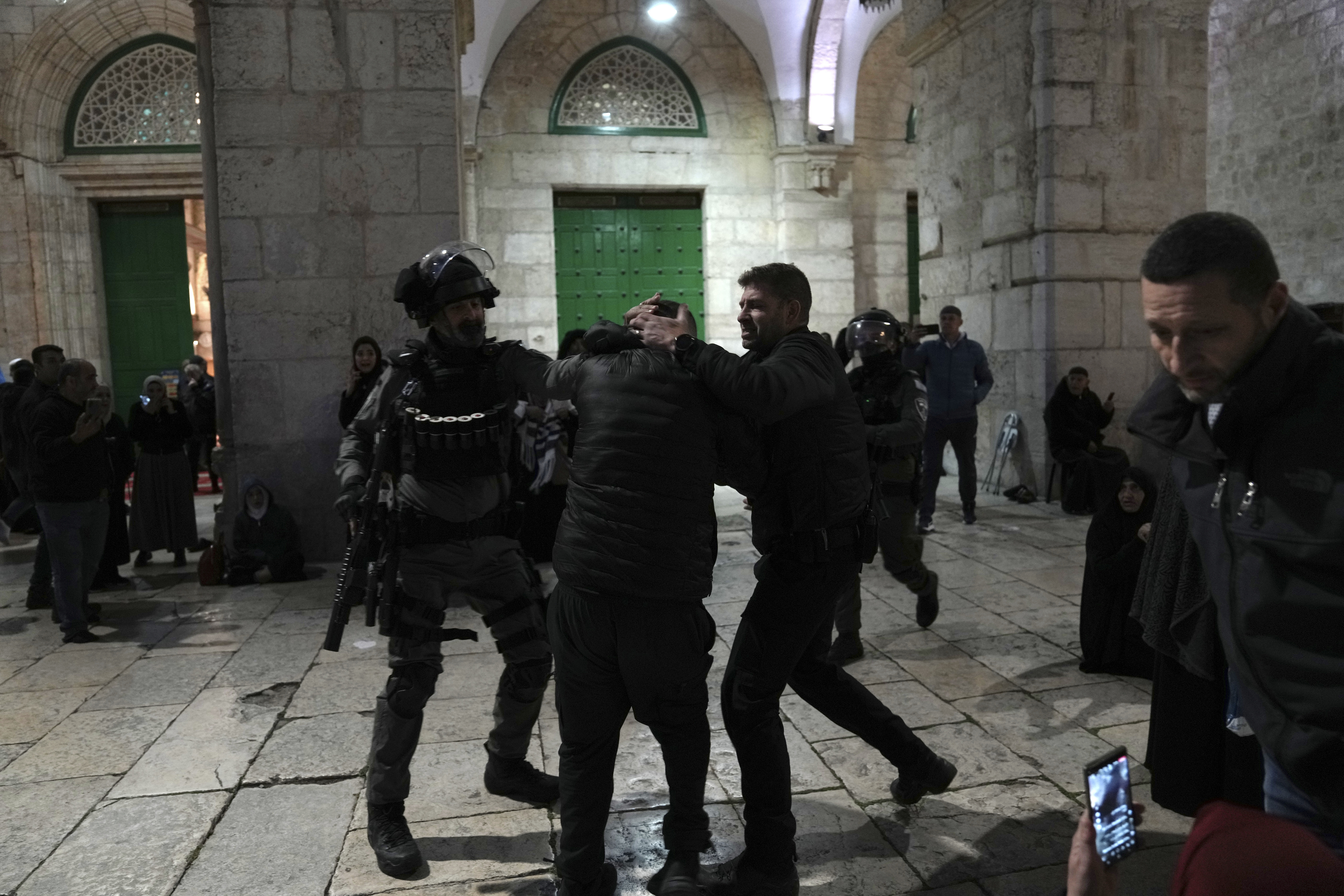 Israeli police detain a Palestinian worshipper at the Al-Aqsa Mosque compound