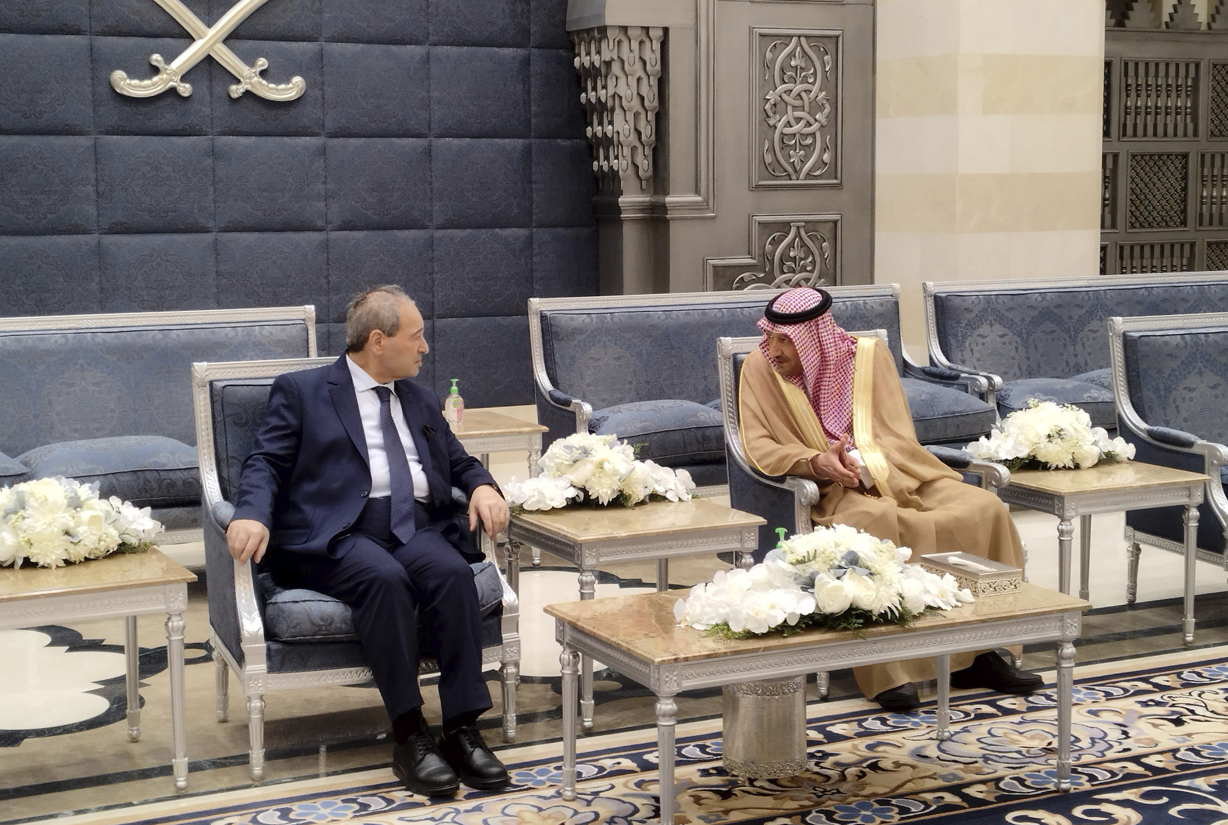 Saudi Deputy Foreign Minister Waleed Al-Khuraiji, right, meets with Syrian Foreign Minister Faisal Mekdad, upon his arrival at King Abdulaziz International Airport, in Jeddah, Saudi Arabia.