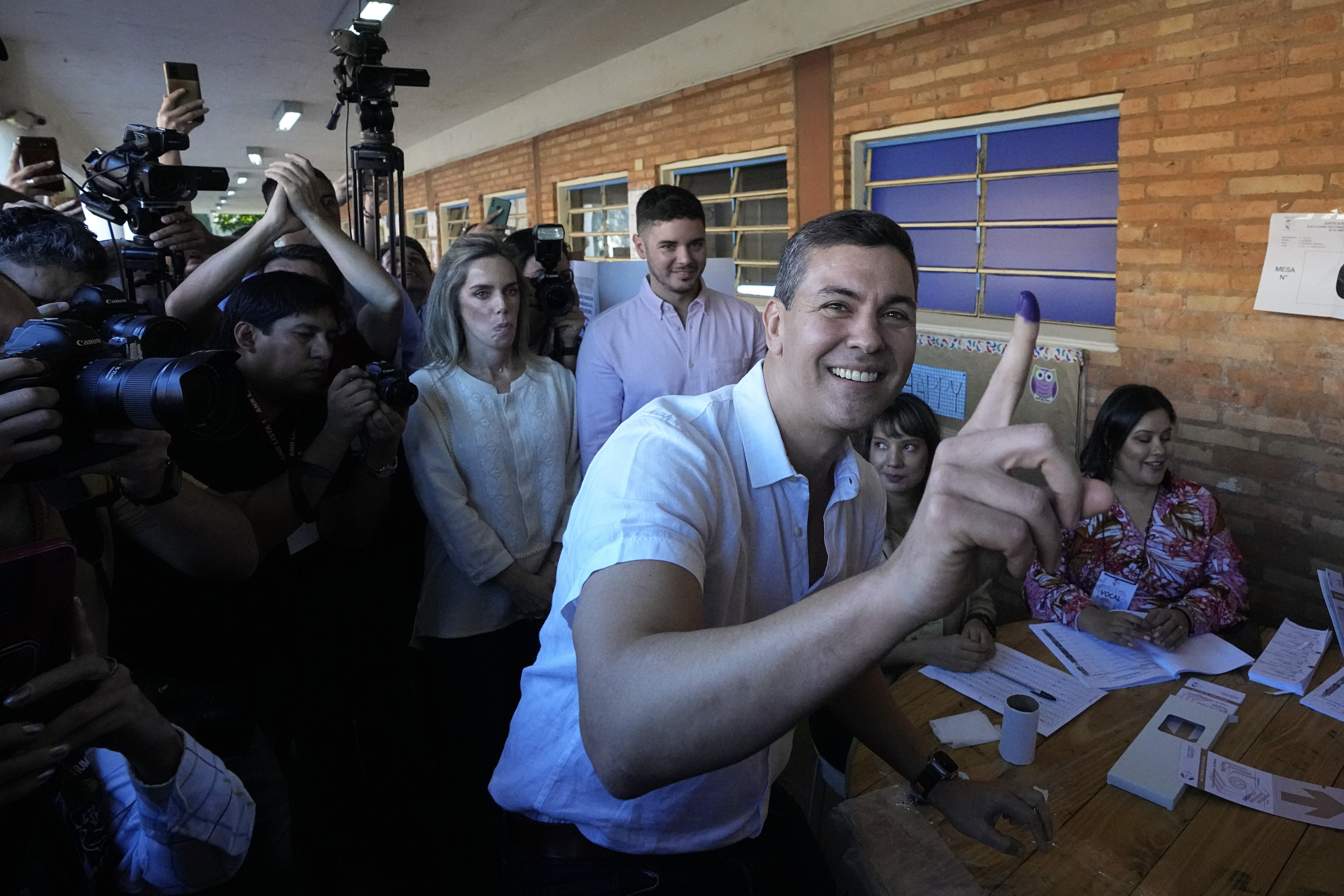 Santiago Pena, presidential candidate of the Colorado ruling party, shows his finger marked with ink after voting at a polling station during general elections in Asuncion, Sunday, April 30, 2023. (AP Photo/Jorge Saenz)