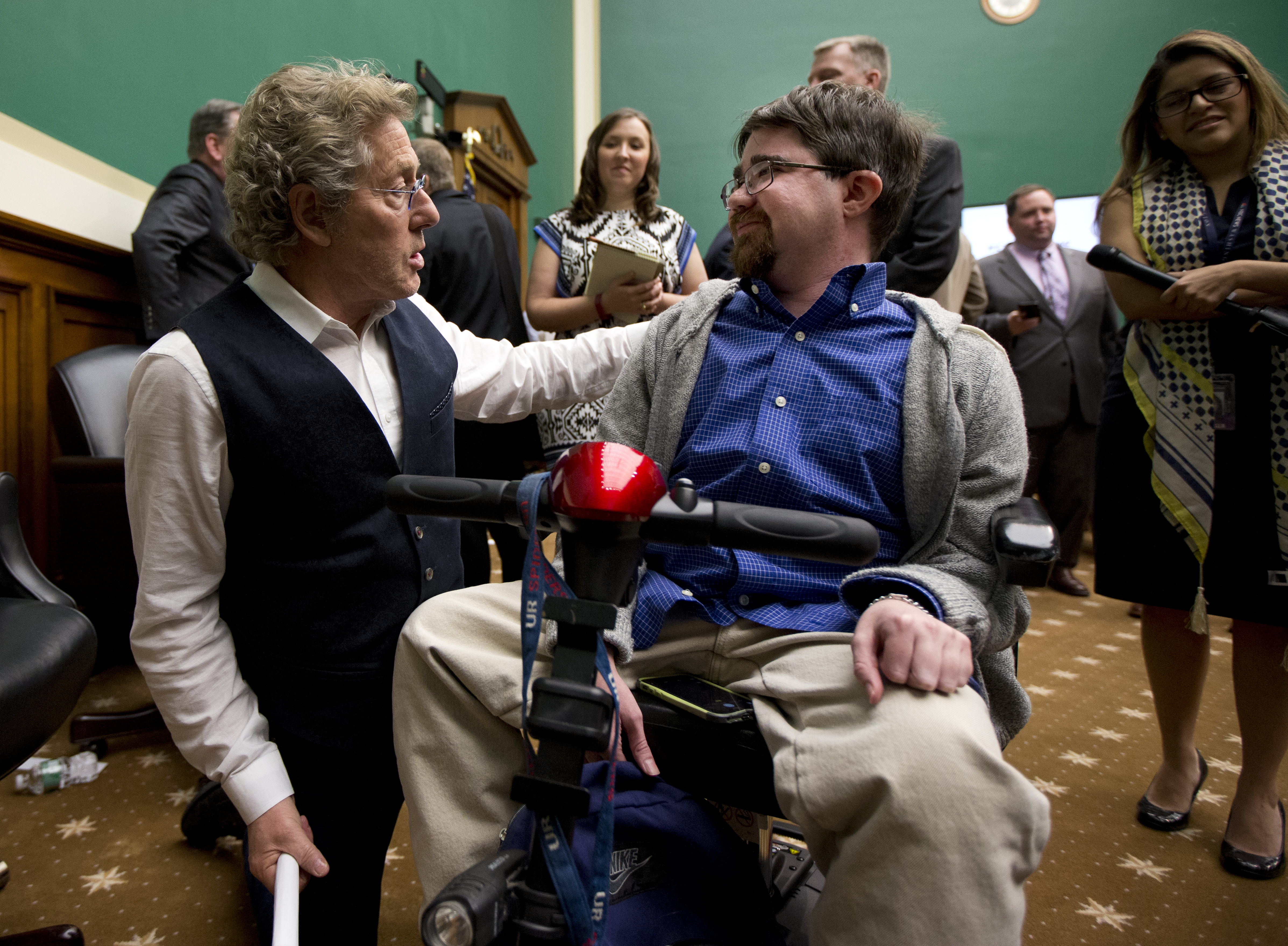 Roger Daltrey, lead singer of the English rock band "The Who" and co-founder of Teen Cancer America, talks to Buddy Cassidy, right, from Annandale, Va., on Capitol Hill in Washington, Wednesday, March 23, 2016, at the conclusion of a conversation on child cures hosted by the House Energy and Commerce Committee. Cassidy, 26, who suffers from duchenne muscular dystrophy, was invited by Daltrey to his concert as his guest. (AP Photo/Manuel Balce Ceneta)