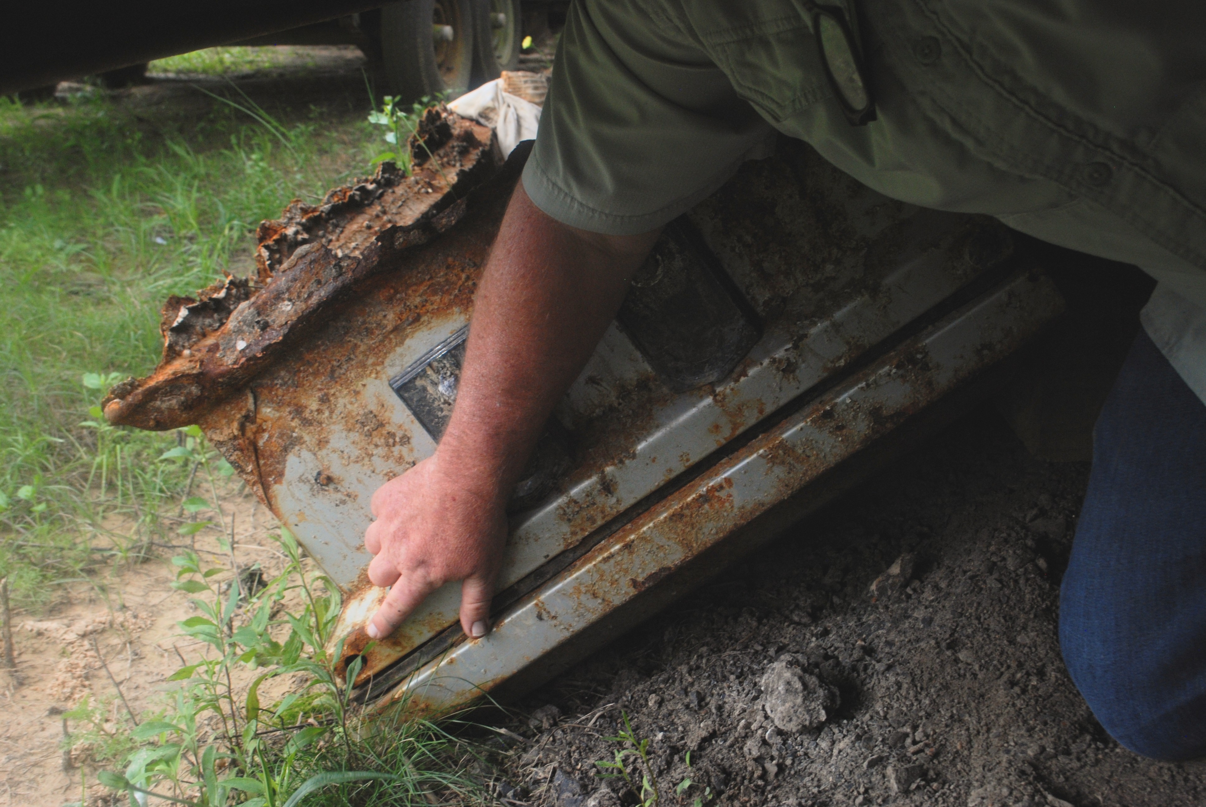 A photo of someone holding a coffin.