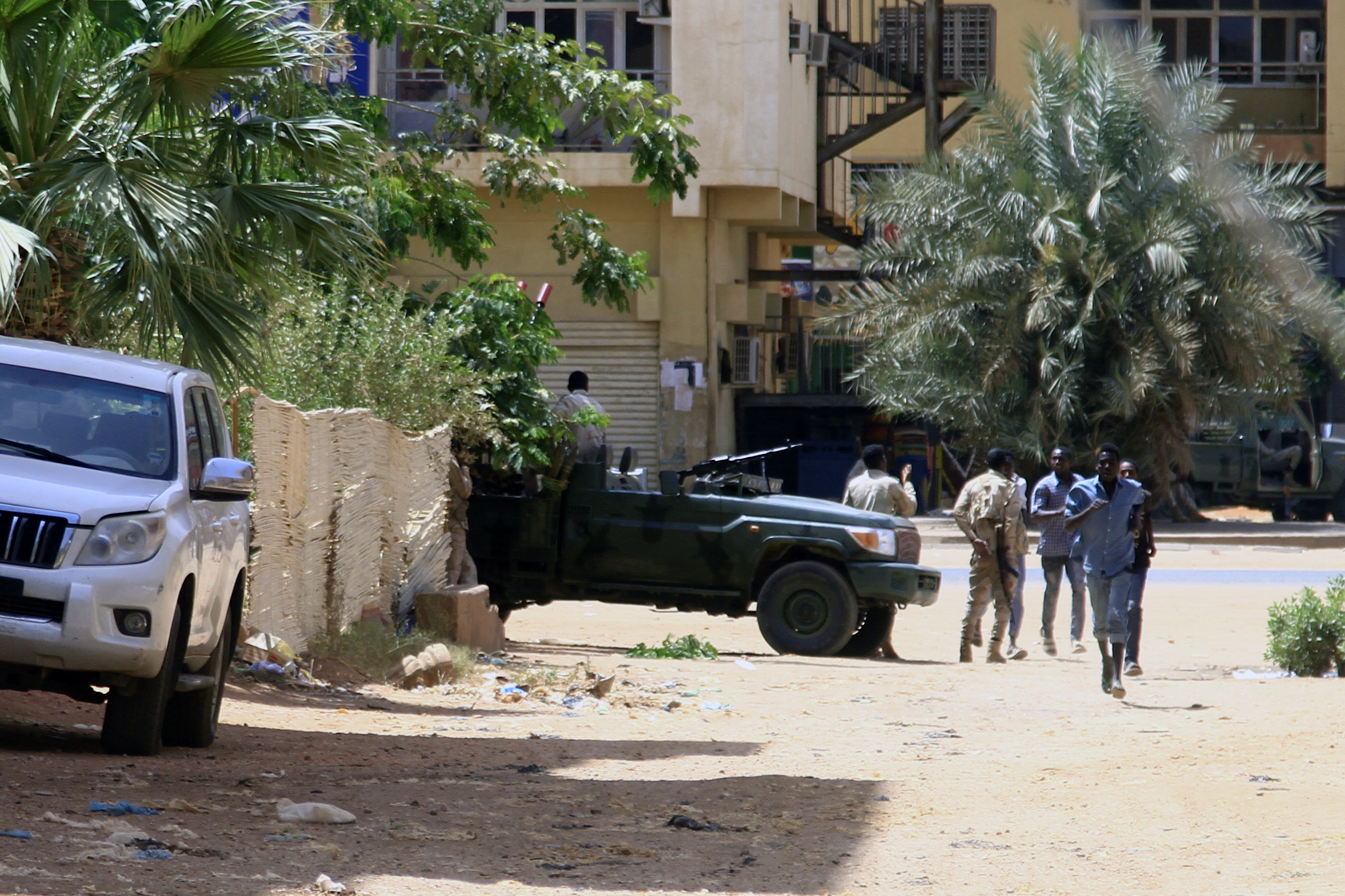 People walk past a military vehicle in Khartoum on Saturday