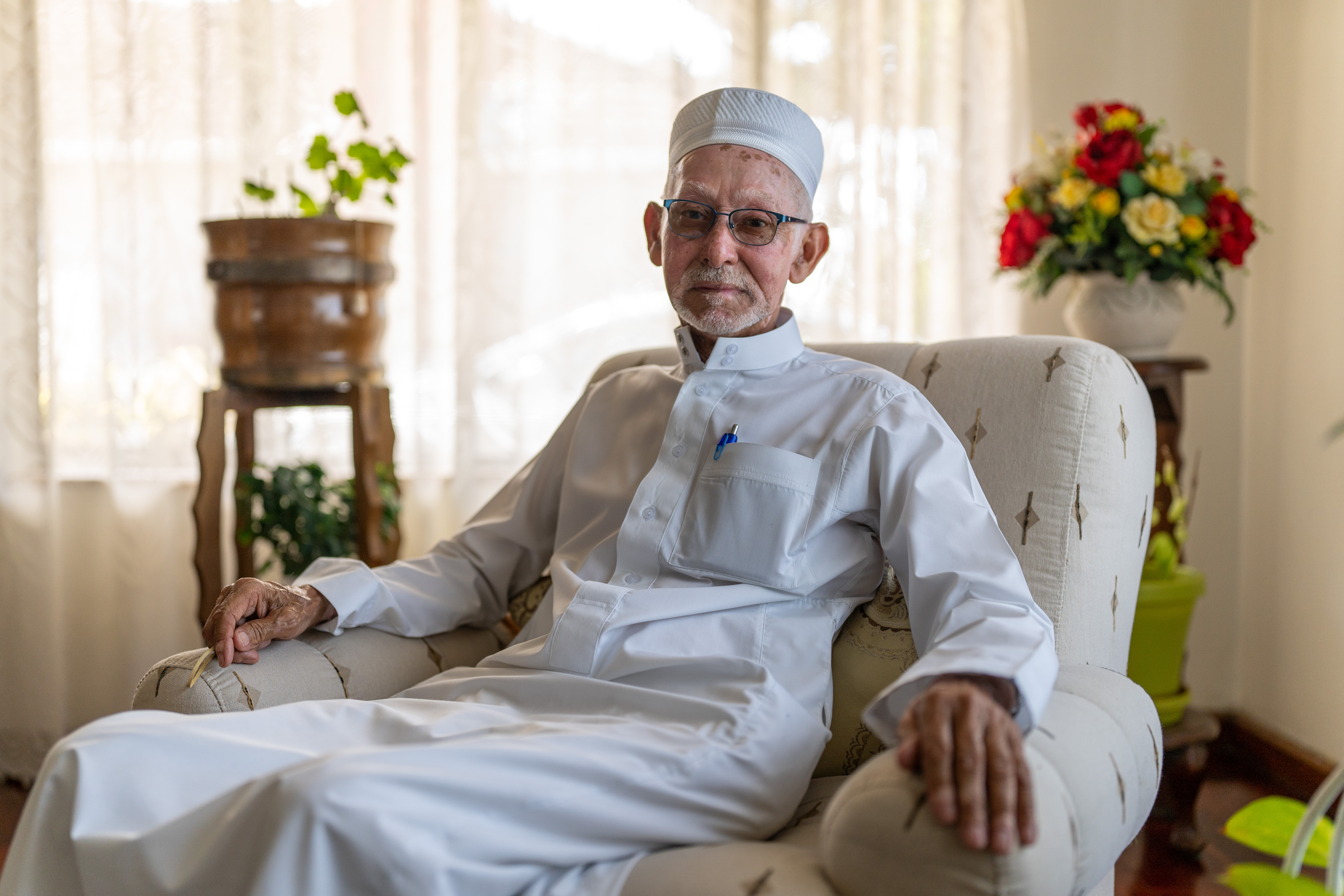 A photo of Imam Yusuf Pandy sitting in a chair.