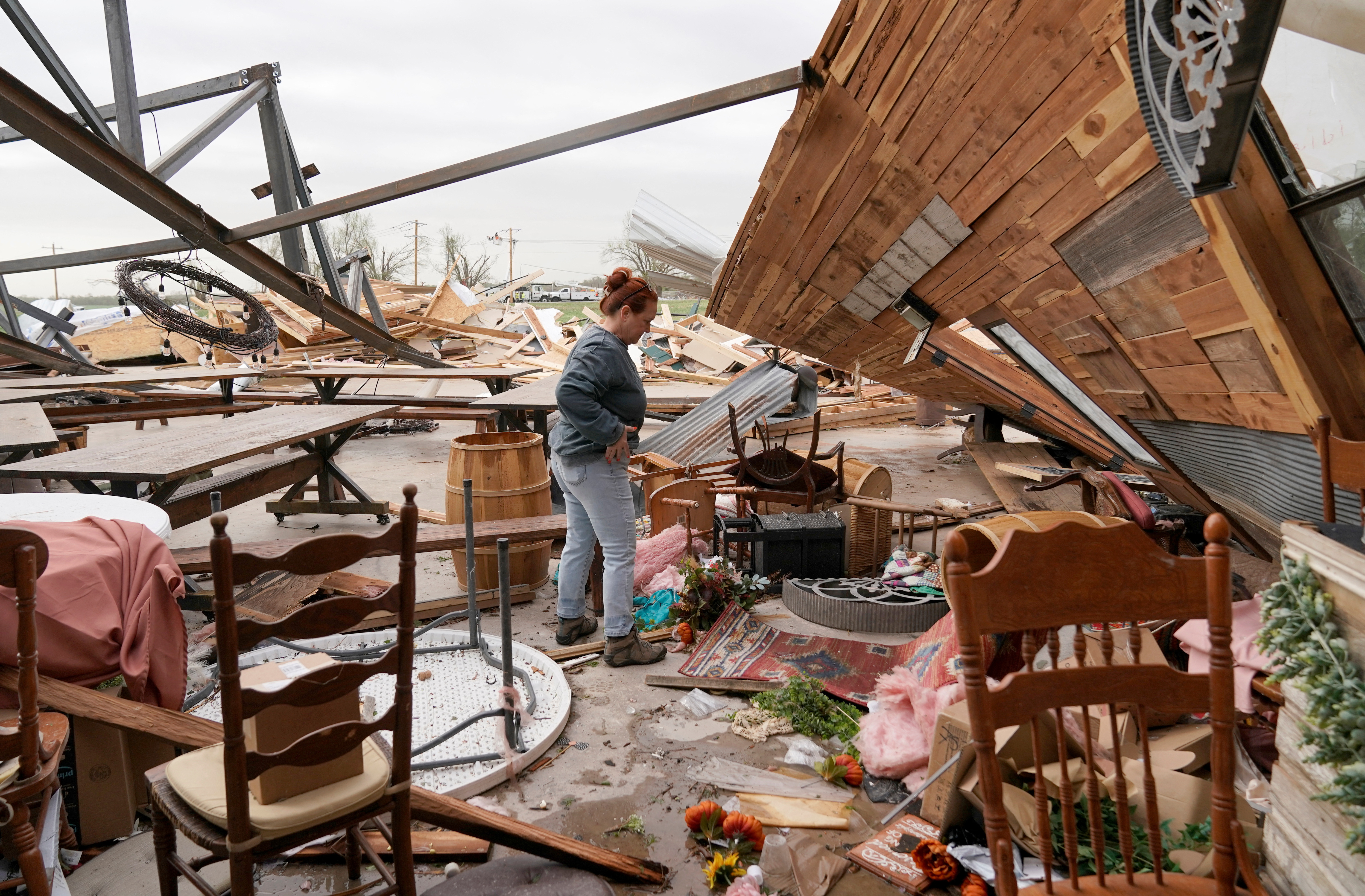 A resident surveys the remnants of a building destroyed by the storm