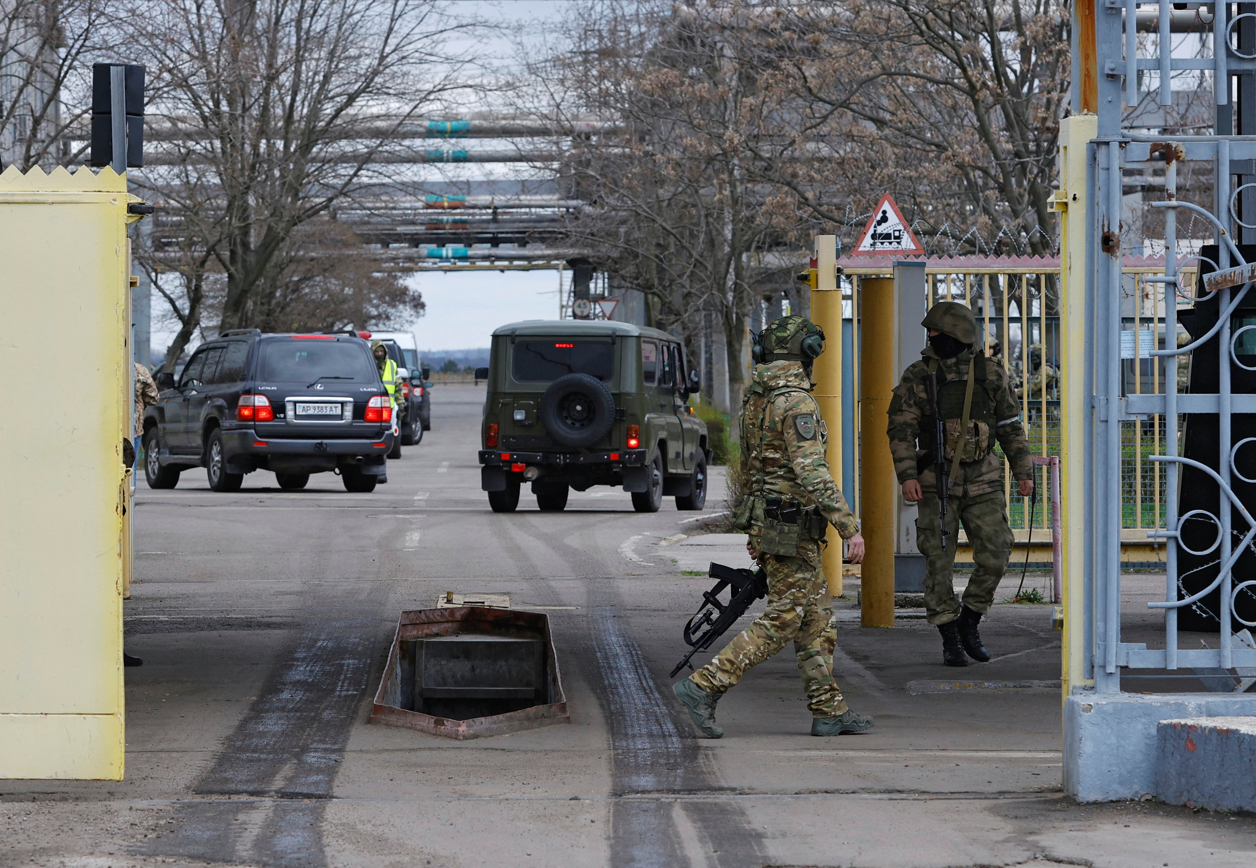 Russian service members guard the entrance to the Zaporizhzhia Nuclear Power Plant during a visit of the International Atomic Energy Agency (IAEA) expert mission in the course of Russia-Ukraine conflict outside Enerhodar in the Zaporizhzhia region, Russian-controlled Ukraine, March 29, 2023. REUTERS/Alexander Ermochenko