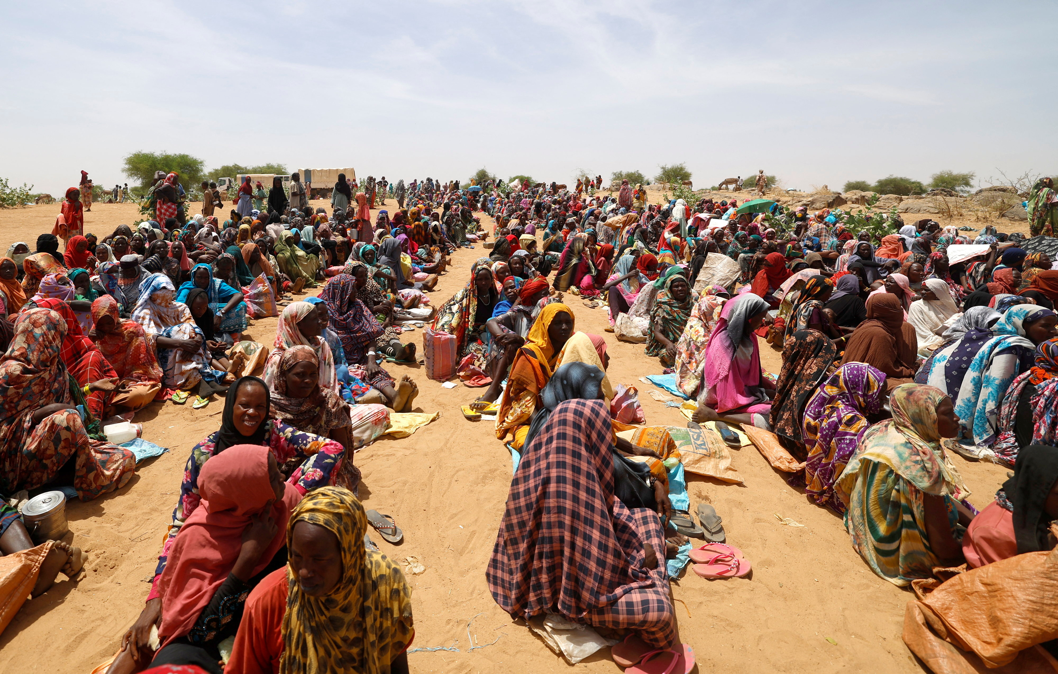 Sudanese refugees, who have fled the violence in their country, wait to receive food rations from World Food Programme