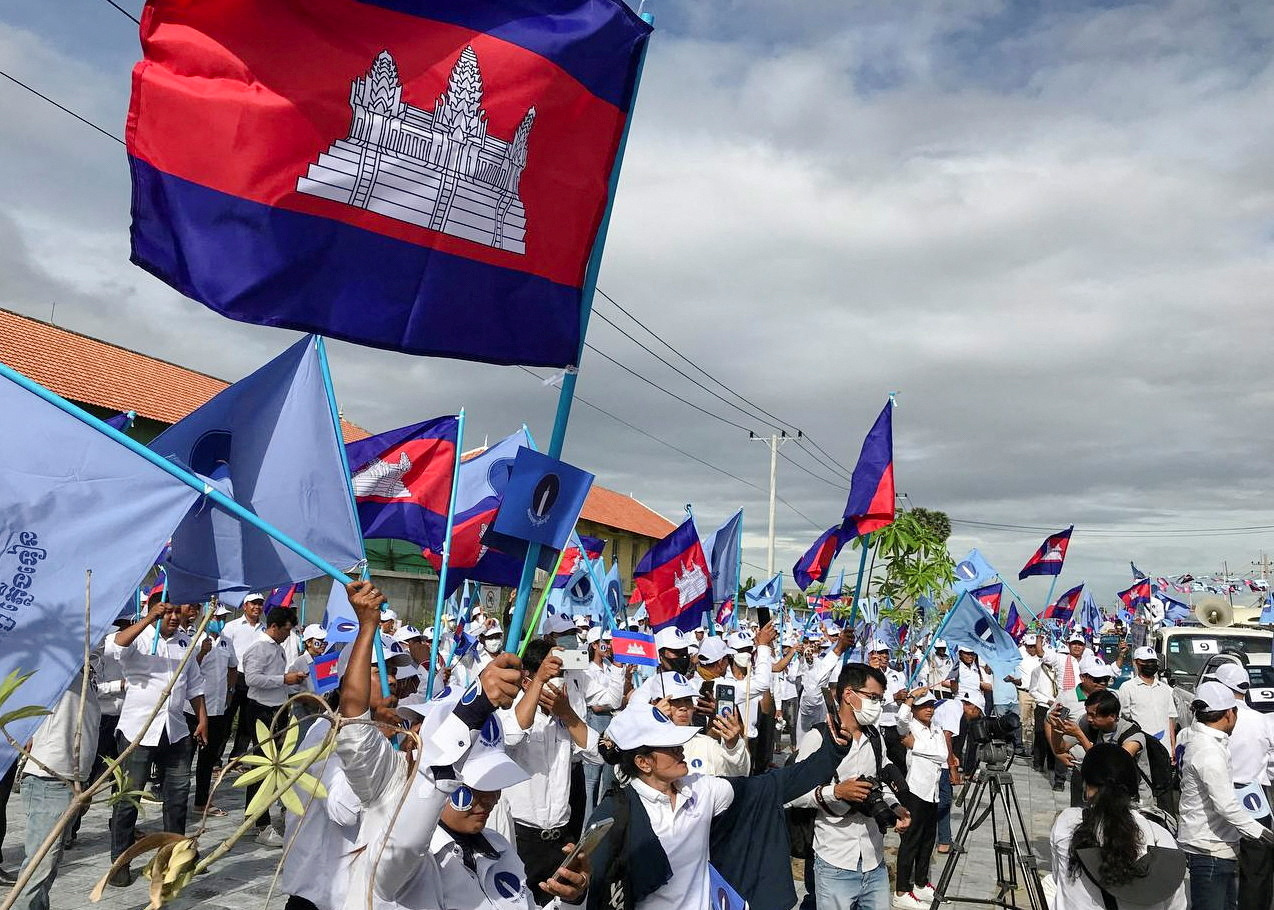 Candlelight party supporters wave Cambodian flags at a rally for local elections last year.