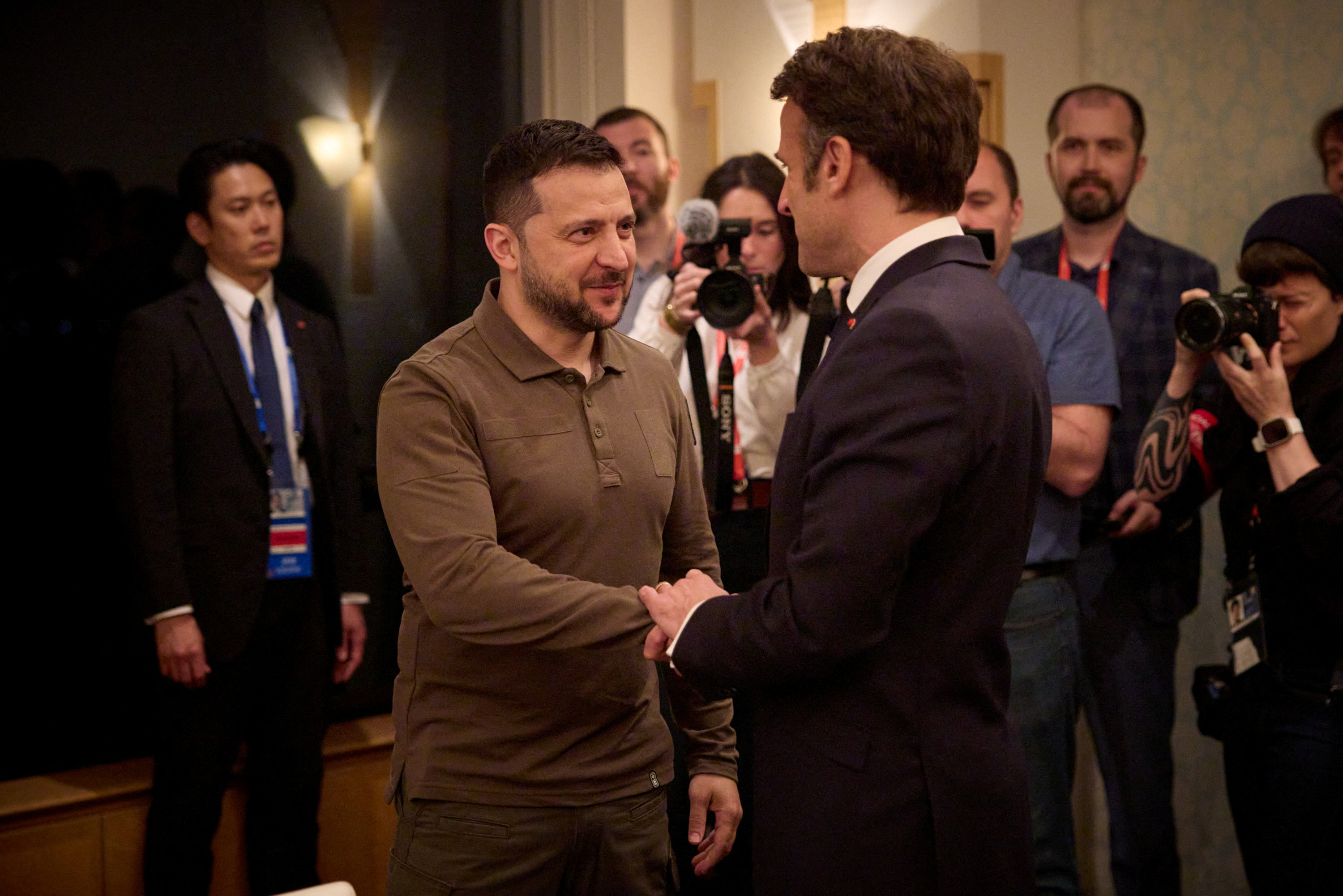 Ukraine's President Volodymyr Zelenskiy and French President Emmanuel Macron shake hands during the G7 leaders' summit in Hiroshima, Japan May 20, 2023.