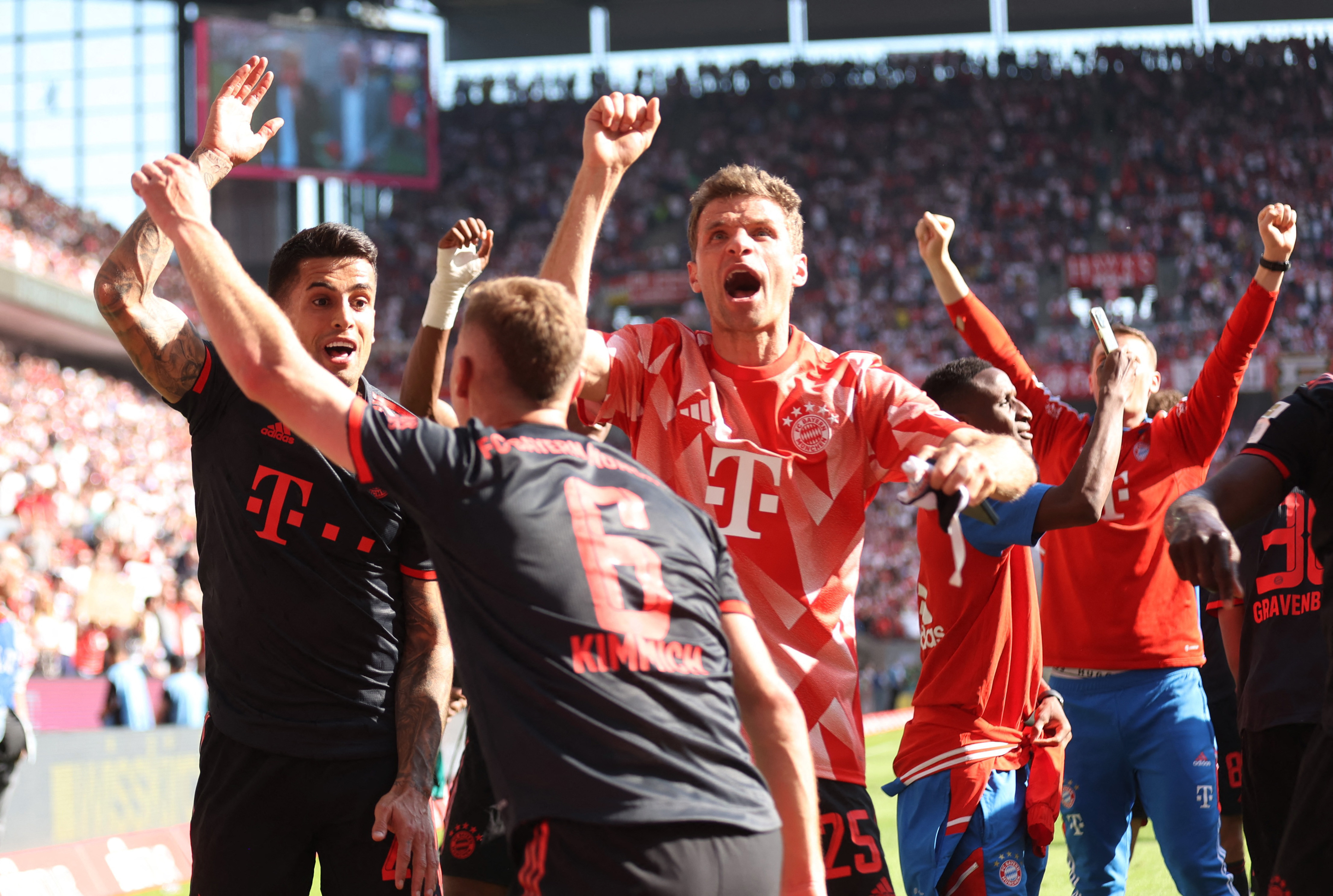 Munich's Thomas Mueller celebrates with teammates after winning the Bundesliga