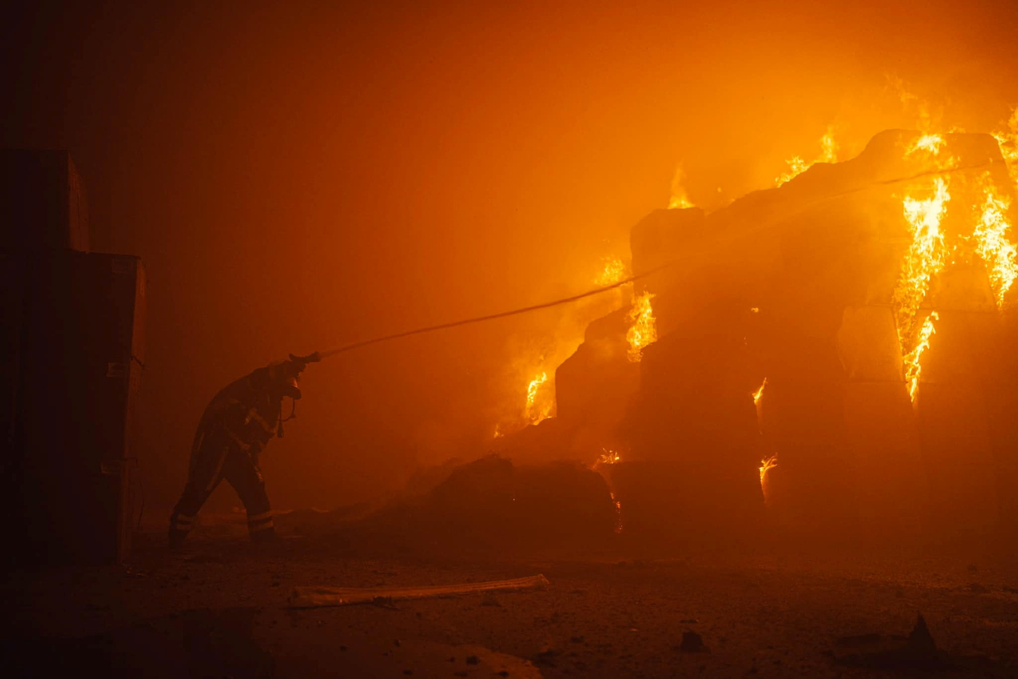 A firefighter works at a site of a tobacco factory damaged during Russian drone strike