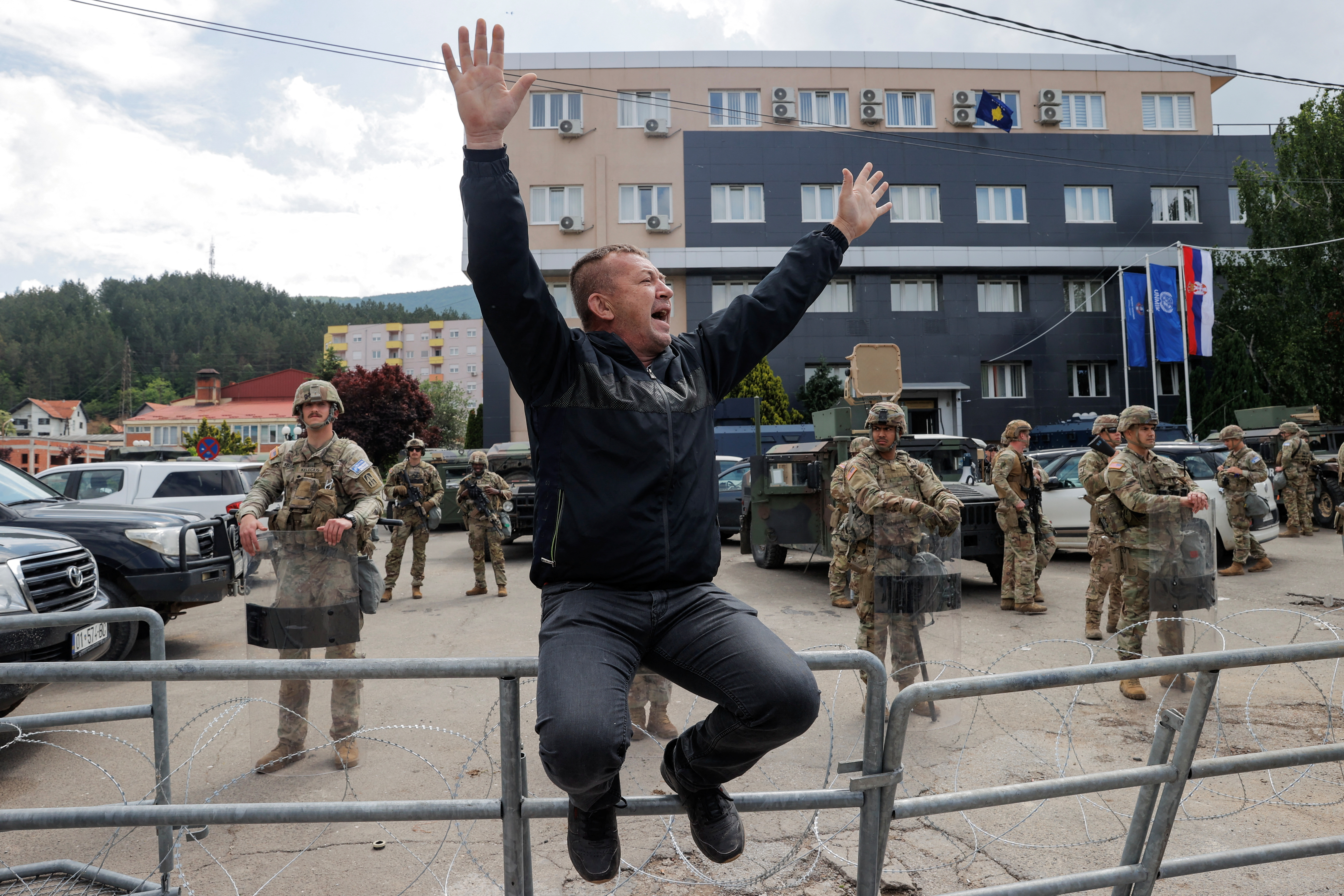 A Kosovo Serb reacts as U.S. KFOR soldiers stand guard in front of the municipality office, in the town of Leposavic, Kosovo, May 29, 2023.