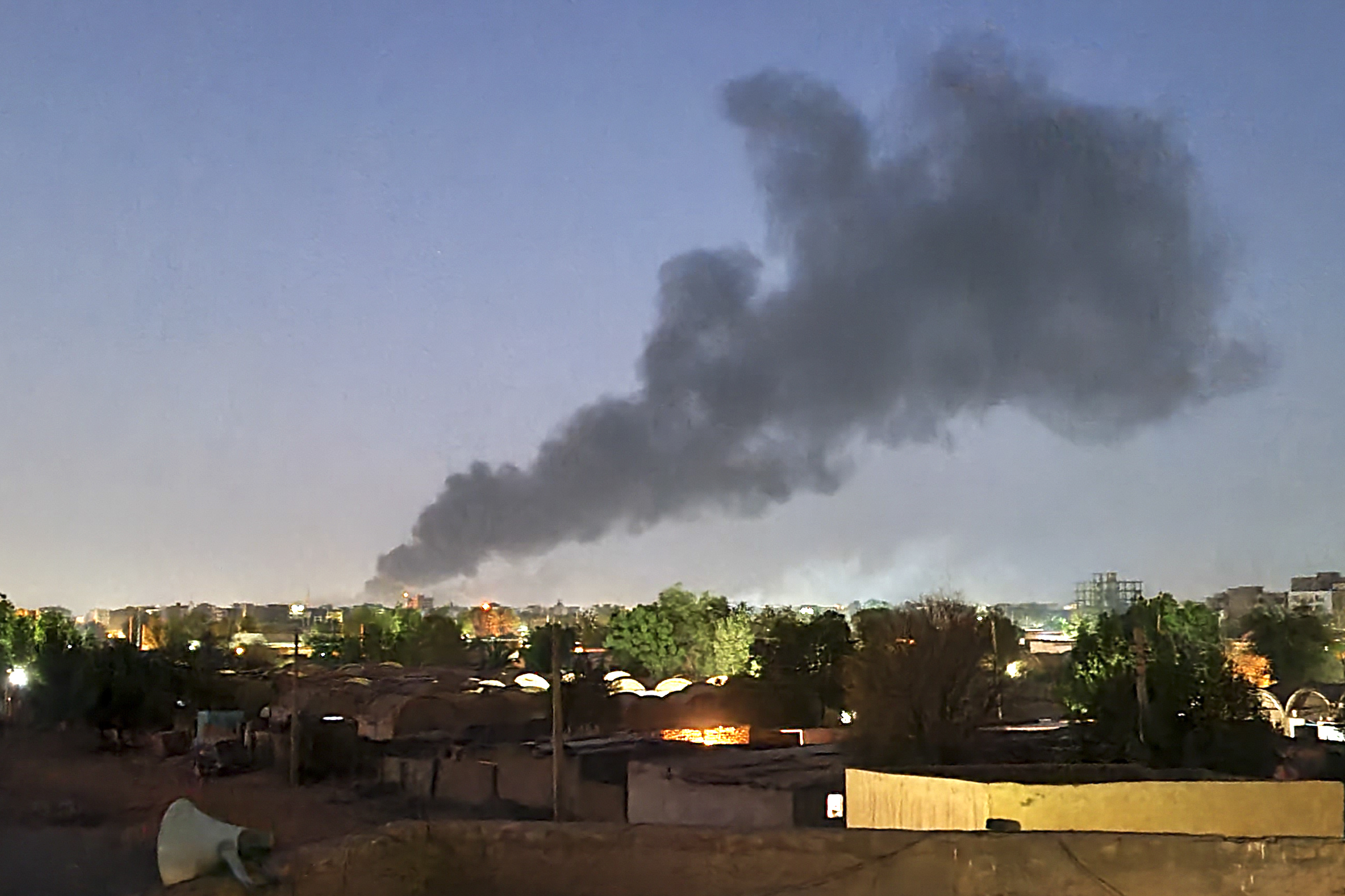 Black smoke billows into the air above Khartoum amid continued fighting between the army and the paramilitary RSF