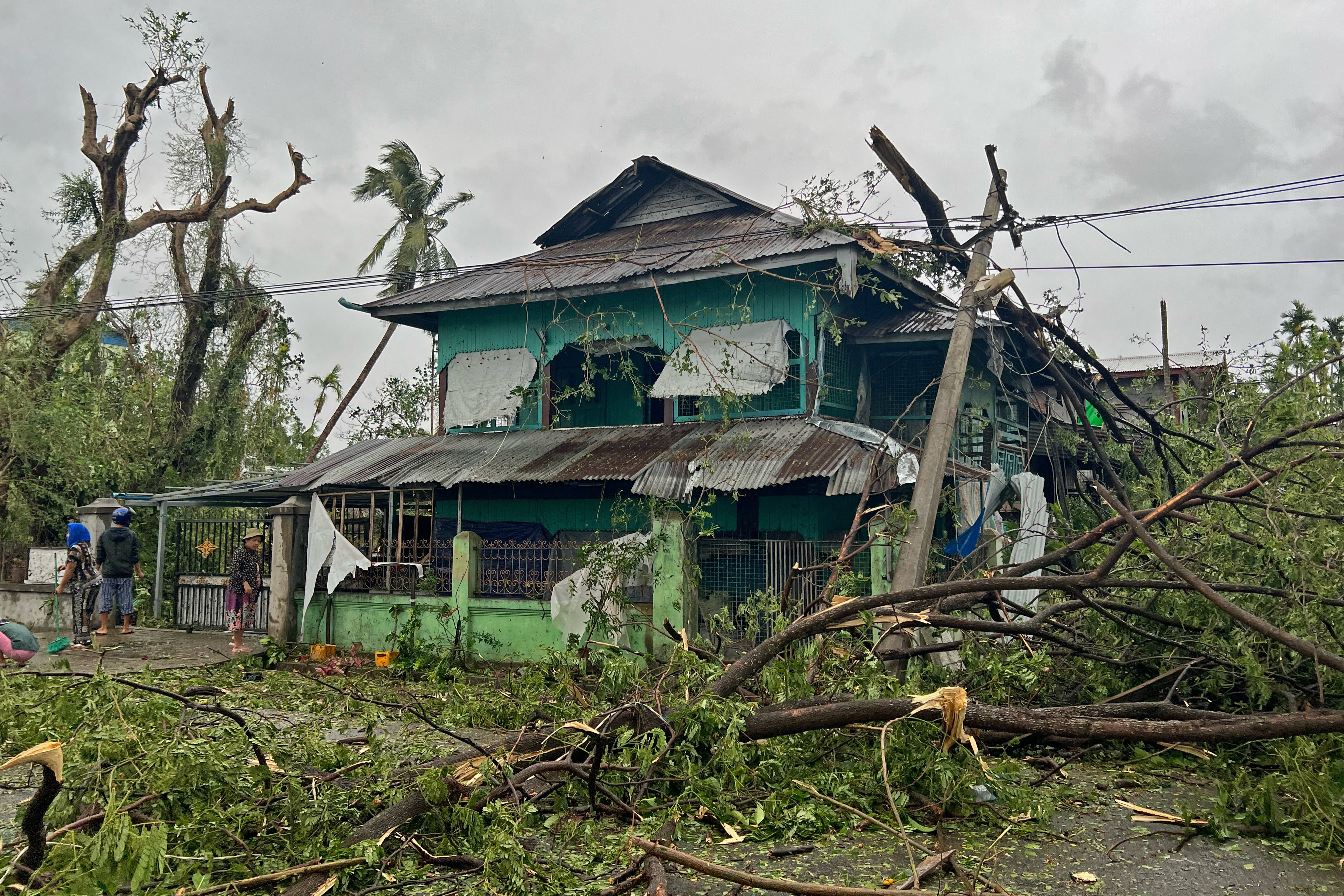 Local residents check the damages after Cyclone Mocha crashed ashore, in Kyauktaw in Myanmar