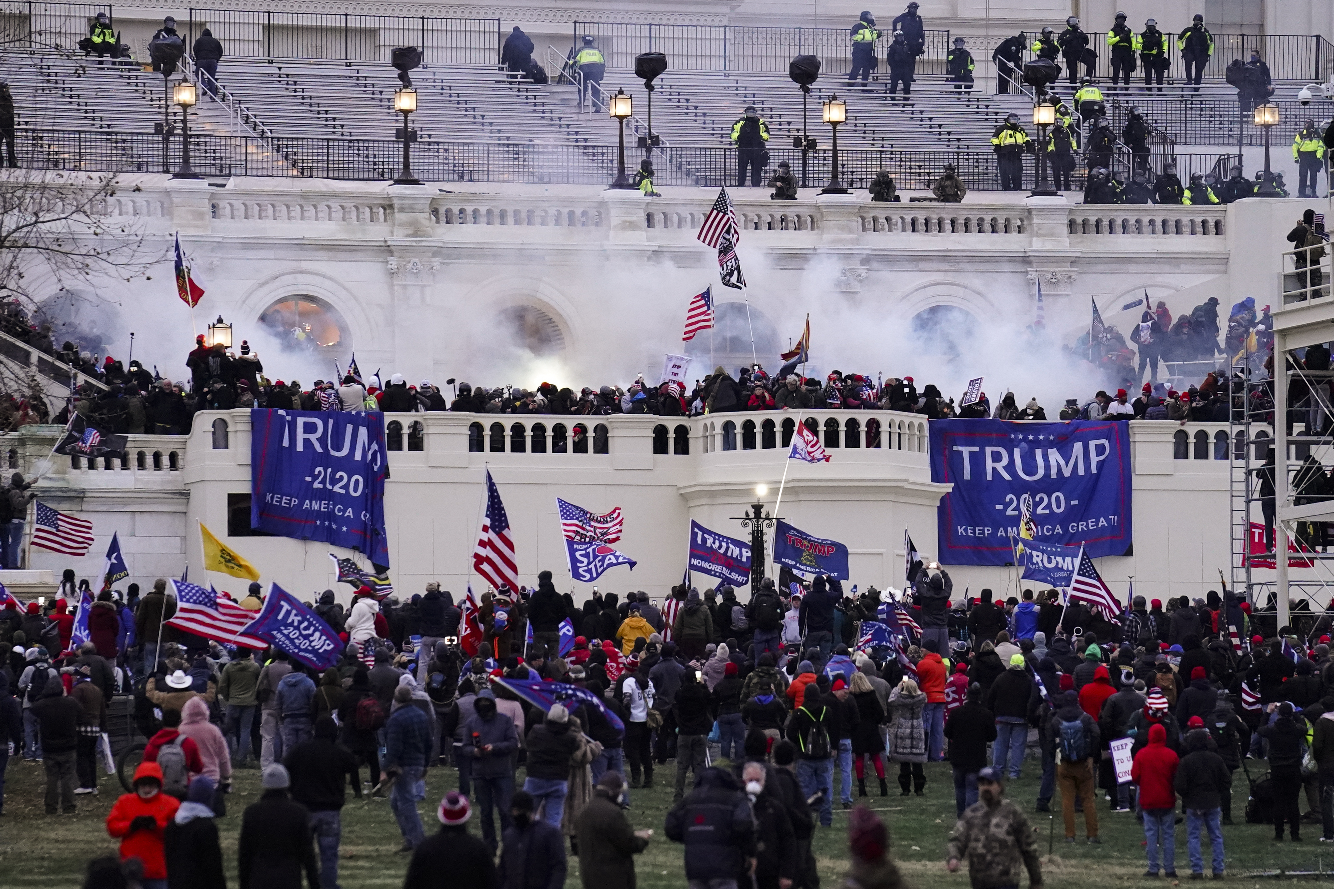 People waving Trump banners and American flags gather before the US Capitol