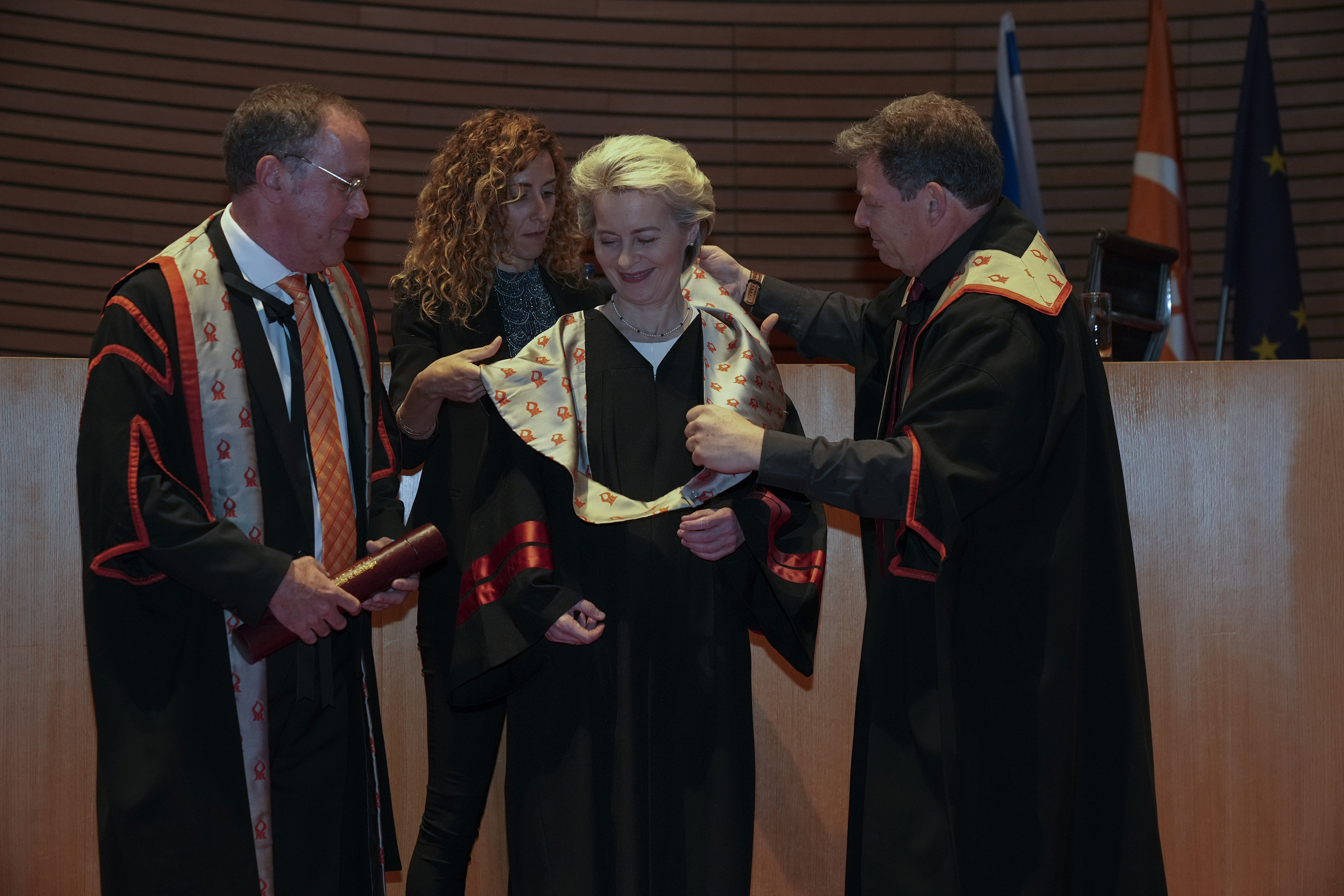 EU Commission President Ursula von der Leyen, center, receives an honorary doctorate from Ben-Gurion University of the Negev by the university president Daniel Chamovitz, left, and professor Chaim Hames, right, in Beersheba, southern Israel, Tuesday, June 14, 2022. The university gave von der Leyen the award in recognition of what it said was her statesmanship, fight against antisemitism and her commitment to enhancing ties with Israel. (AP Photo/Tsafrir Abayov)