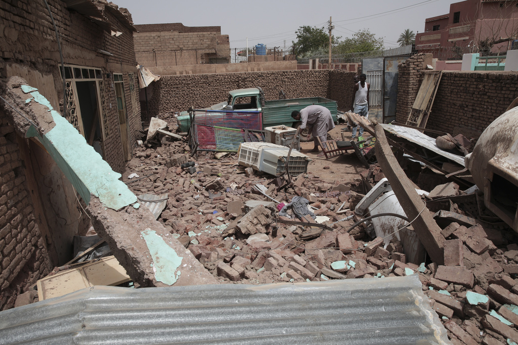 Man cleans debris of a house