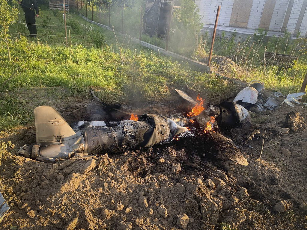 In this photo provided by the Ukrainian Police Press Office, fragments of a Russian rocket which was shot down by Ukraine's air defence system are seen after the night rocket attack in the Kyiv region, Ukraine, Thursday, May 18, 2023. (Ukrainian Police Press Office via AP)