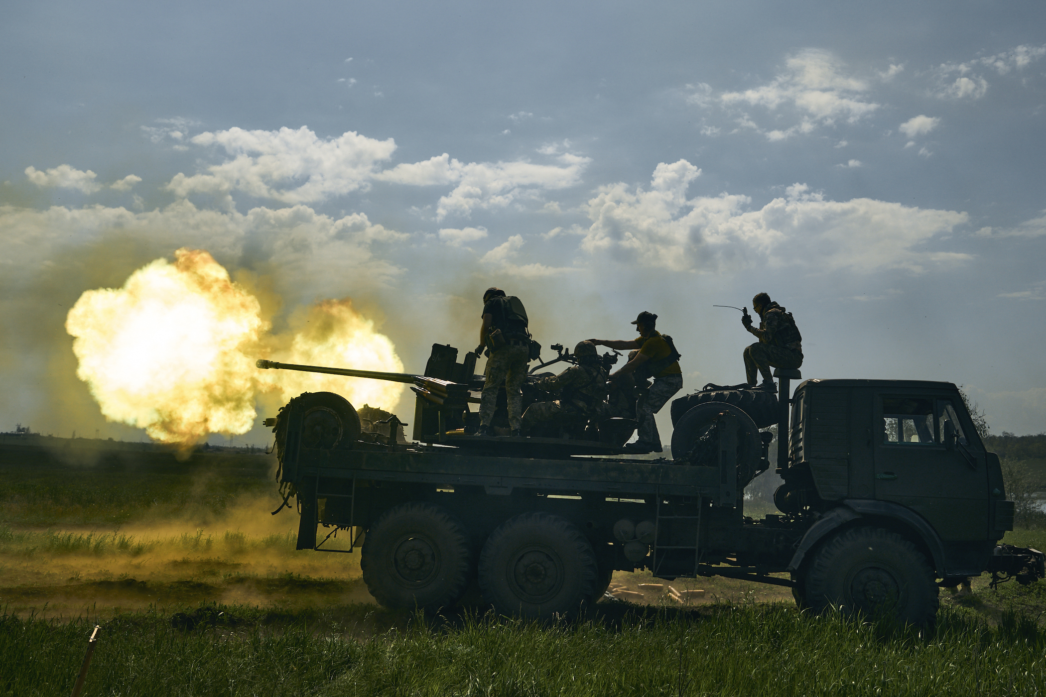 Ukrainian soldiers fire a cannon near Bakhmut,