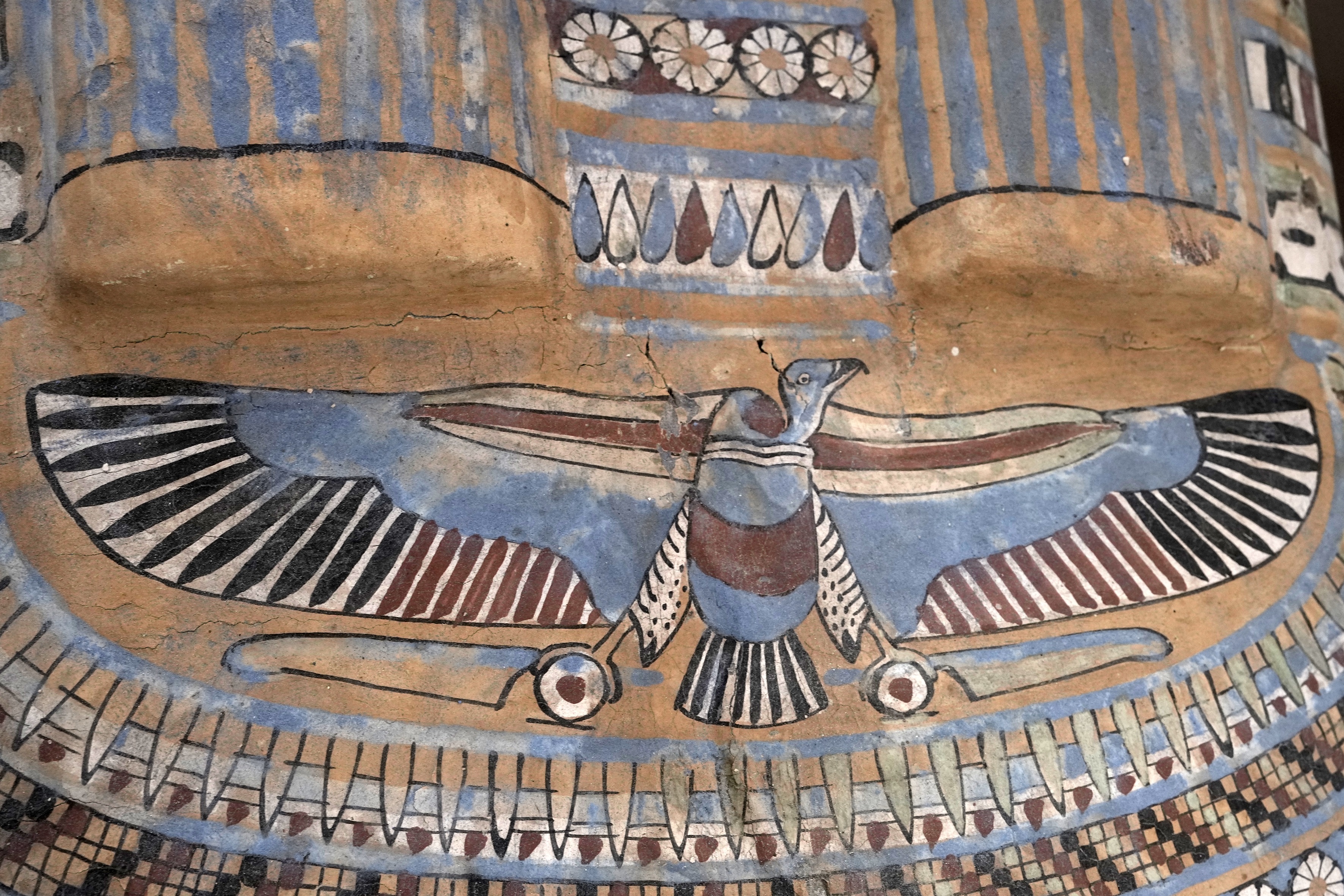 A colored painting is seen on a recently unearthed ancient wooden sarcophagus