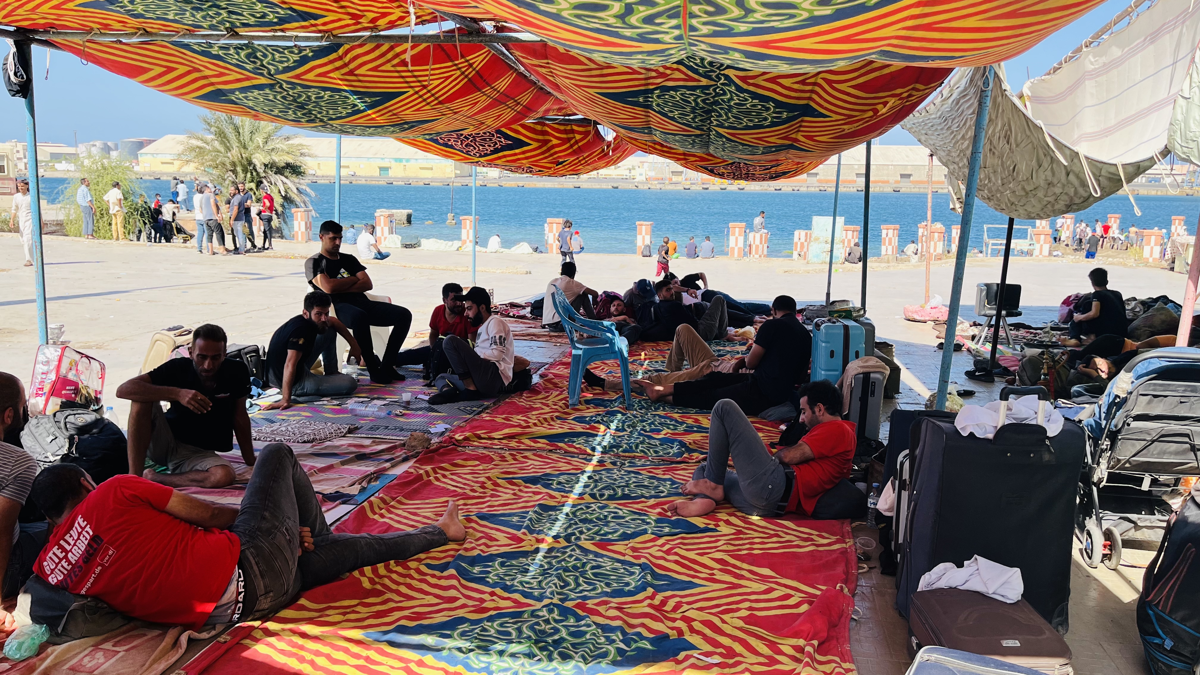 People seek shade in makeshift camps in Port Sudan