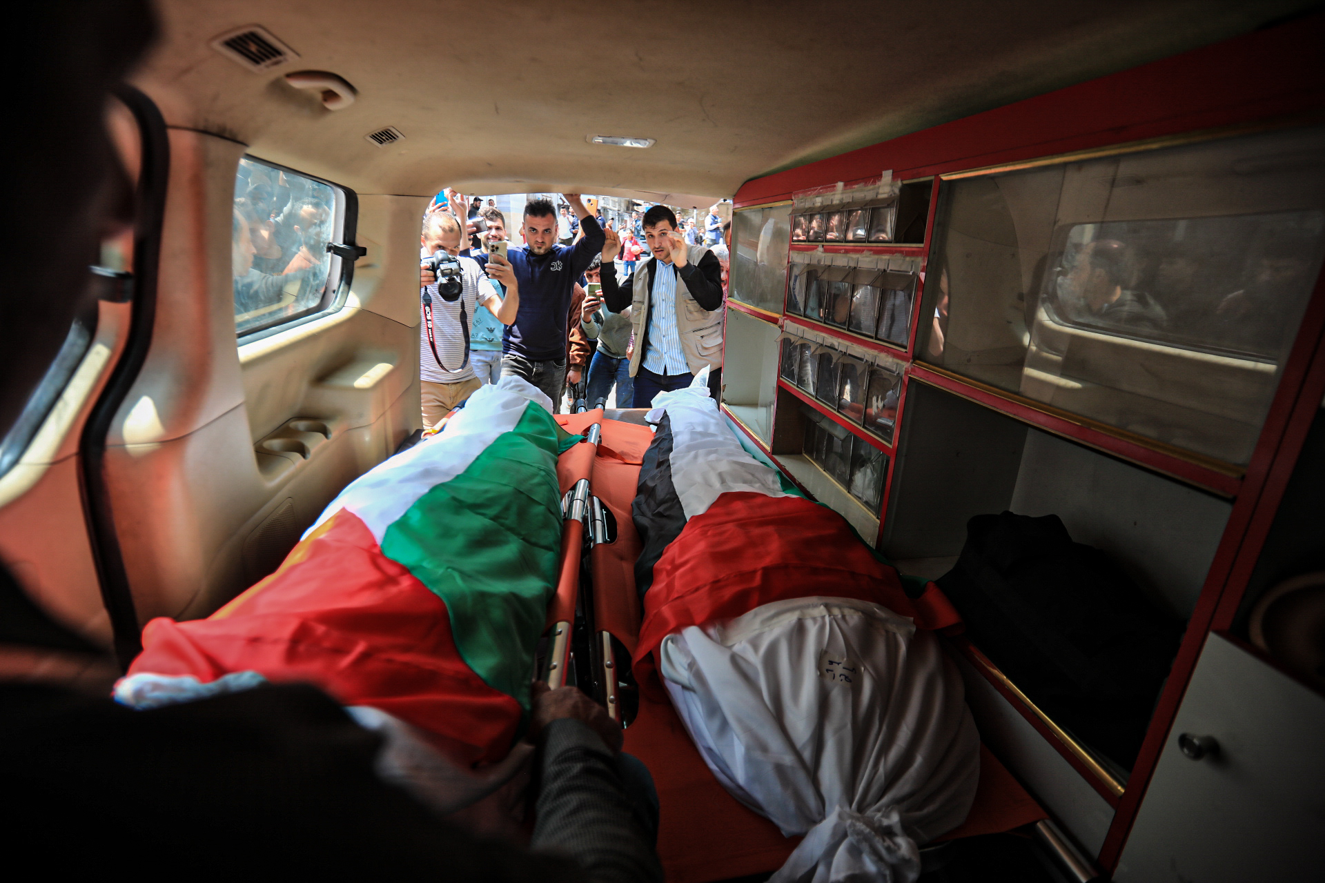 Bodies of sisters Dania and Iman Adass who were killed early on Tuesday on a raid near their home in Al-Tofa neighborhood