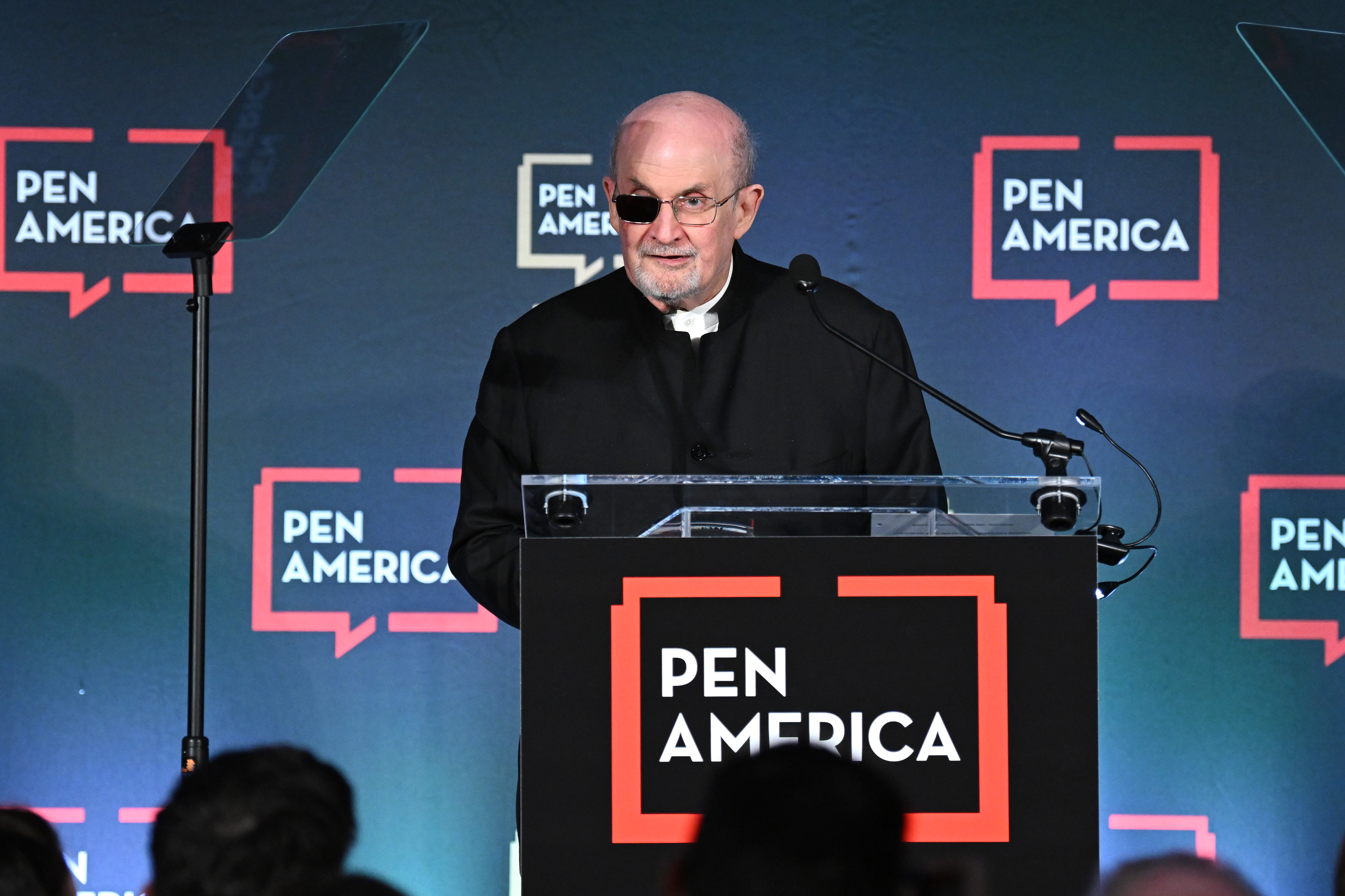 Salman Rushdie speaks on stage at the 2023 PEN America Literary Gala at American Museum of Natural History