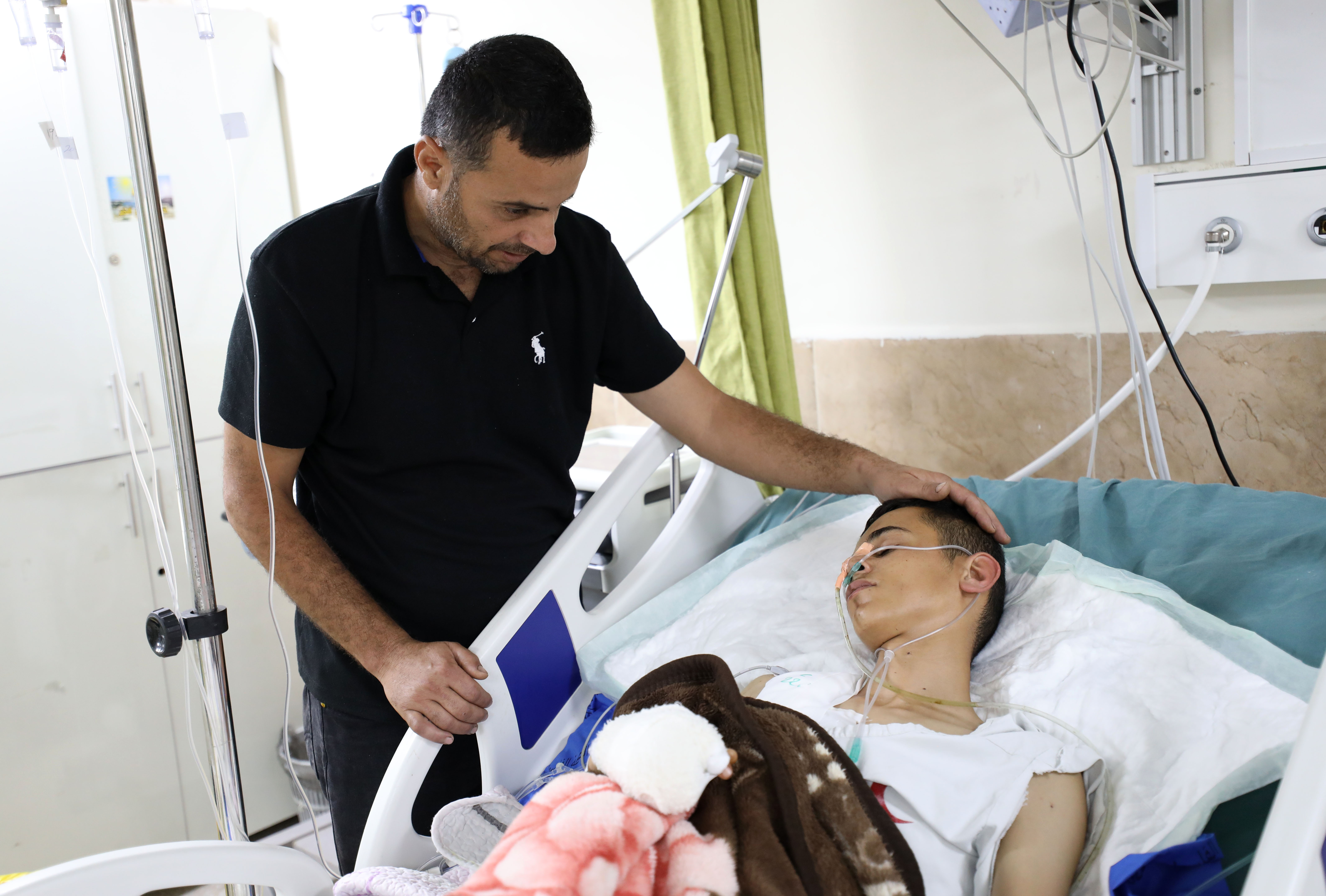 An injured man with his father