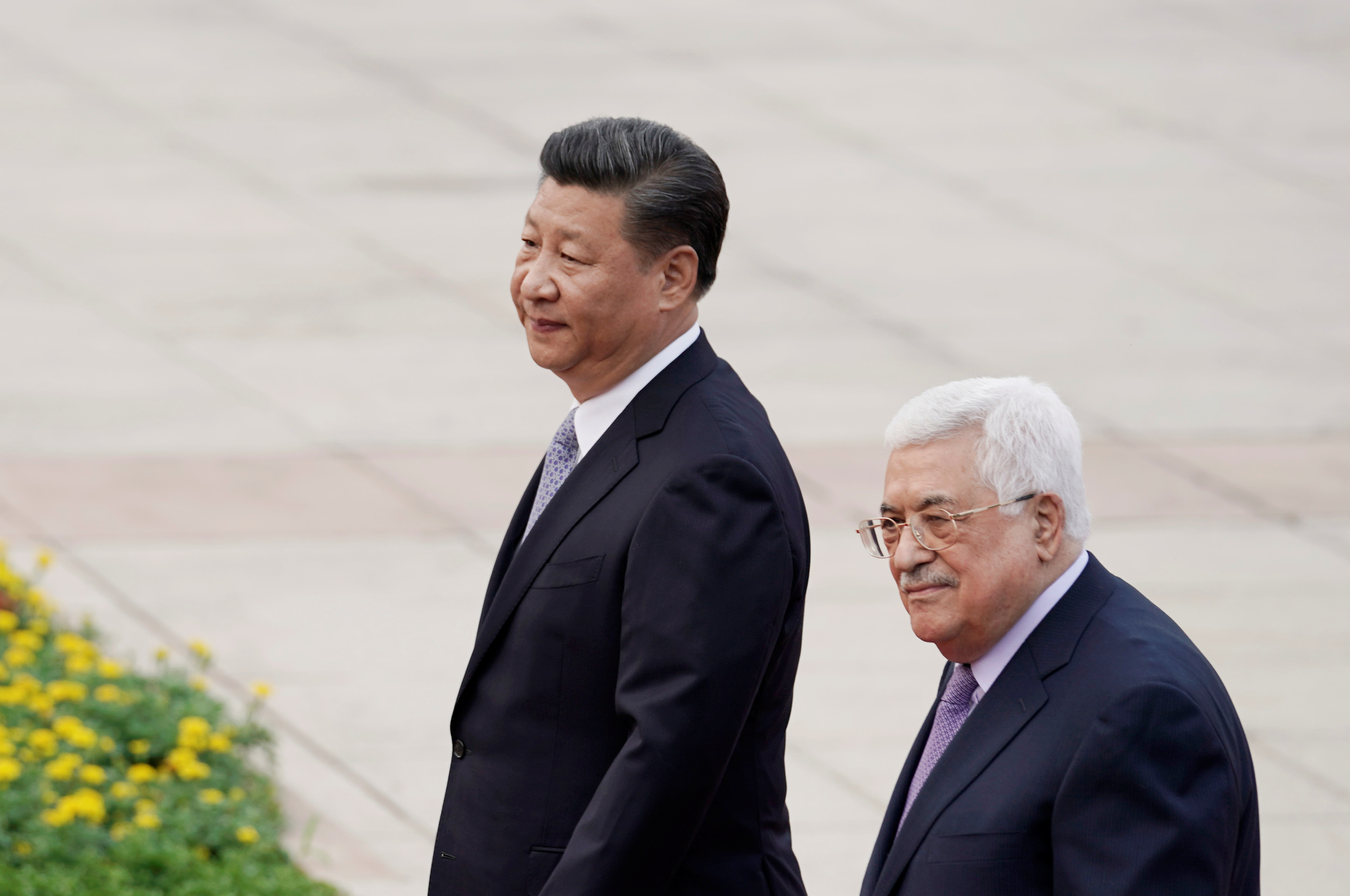President Xi Jinping and President Mahmoud Abbas walking in Beijing
