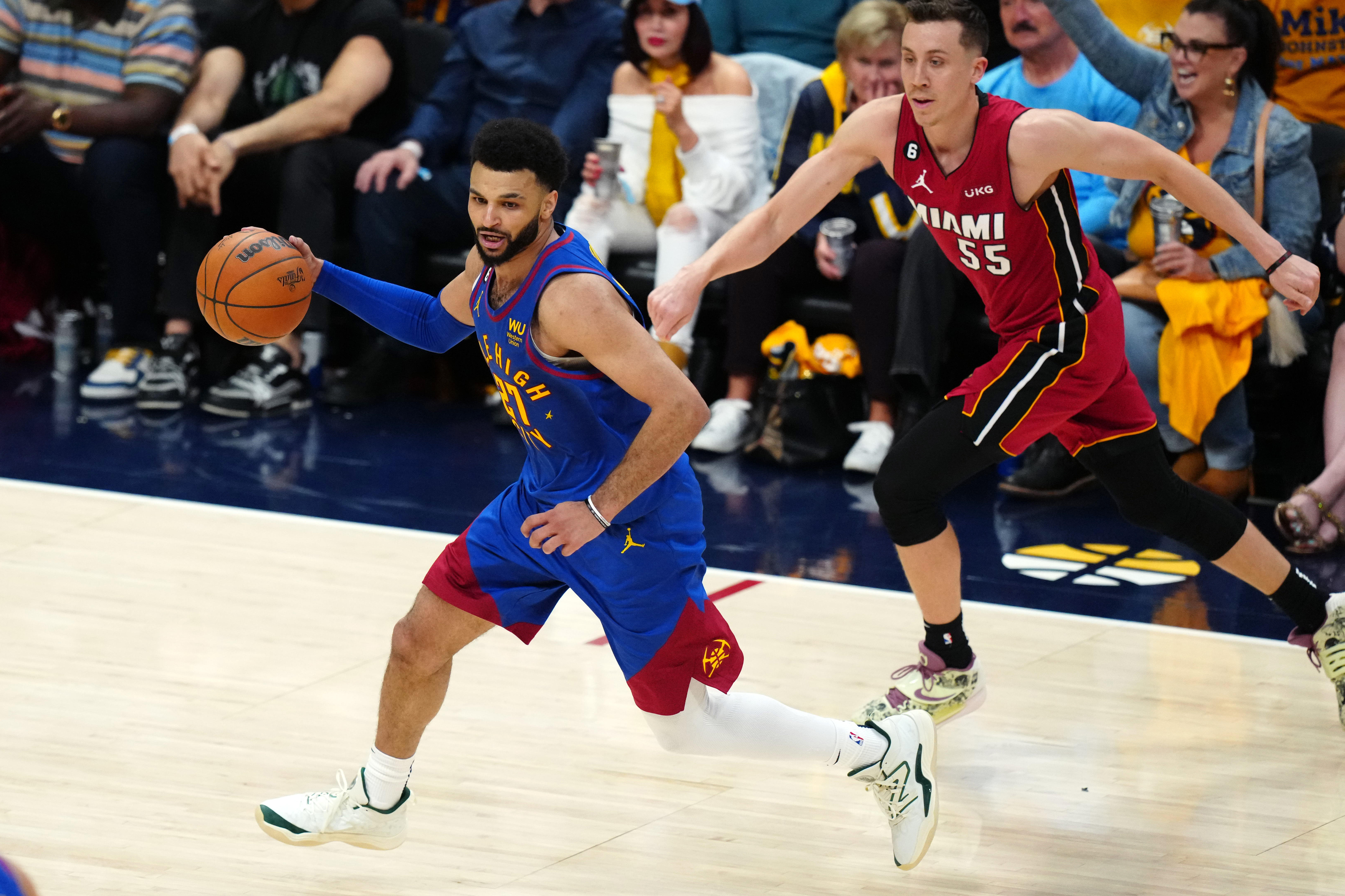 Jun 1, 2023; Denver, CO, USA; Denver Nuggets guard Jamal Murray (27) dribbles the ball ahead of Miami Heat forward Duncan Robinson