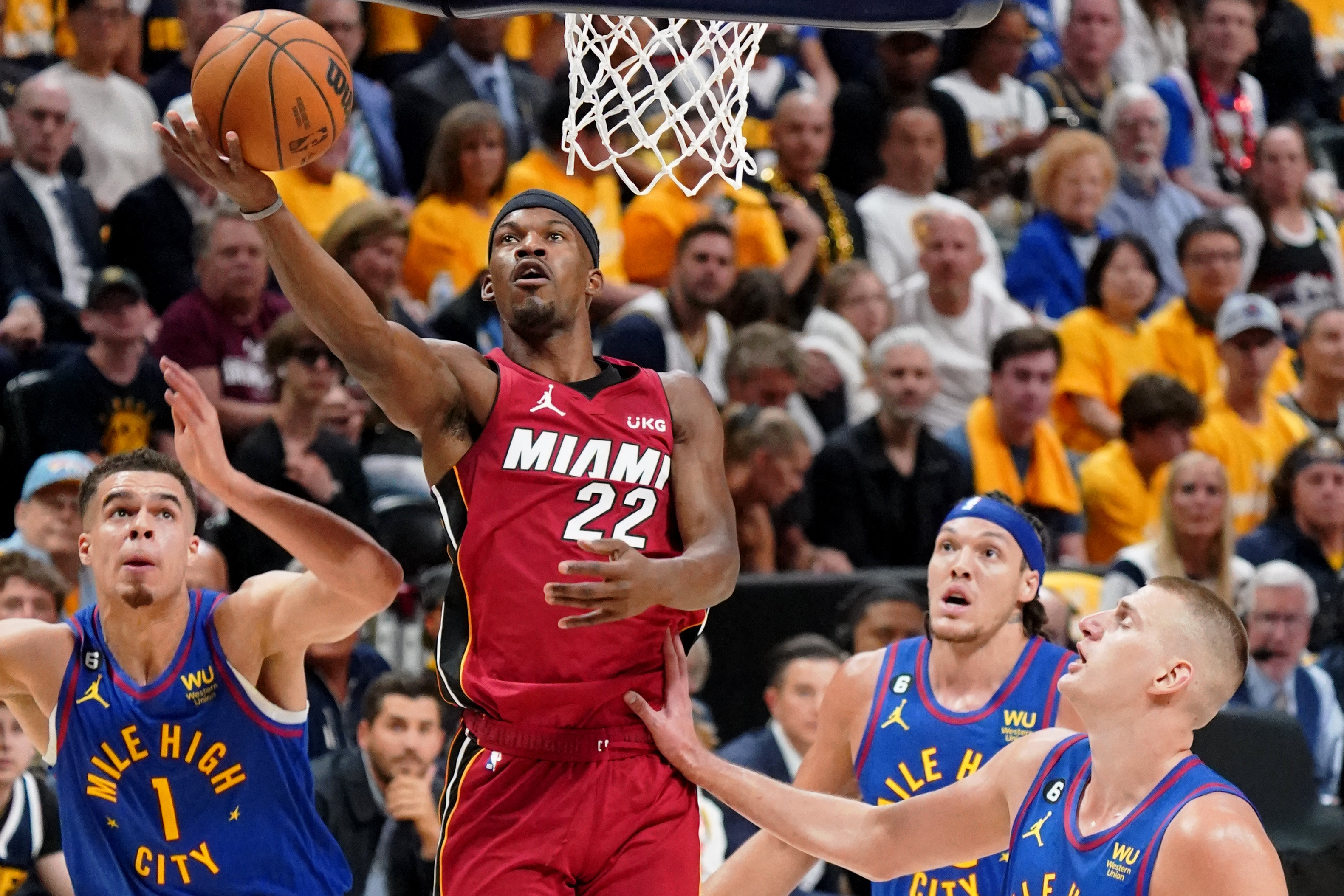 Miami Heat forward Jimmy Butler (22) shoots the ball against Denver Nuggets forward Michael Porter Jr. (1) during the first half in game one of the 2023 NBA Finals at Ball Arena. Mandatory Credit: Kyle Terada-USA TODAY Sports