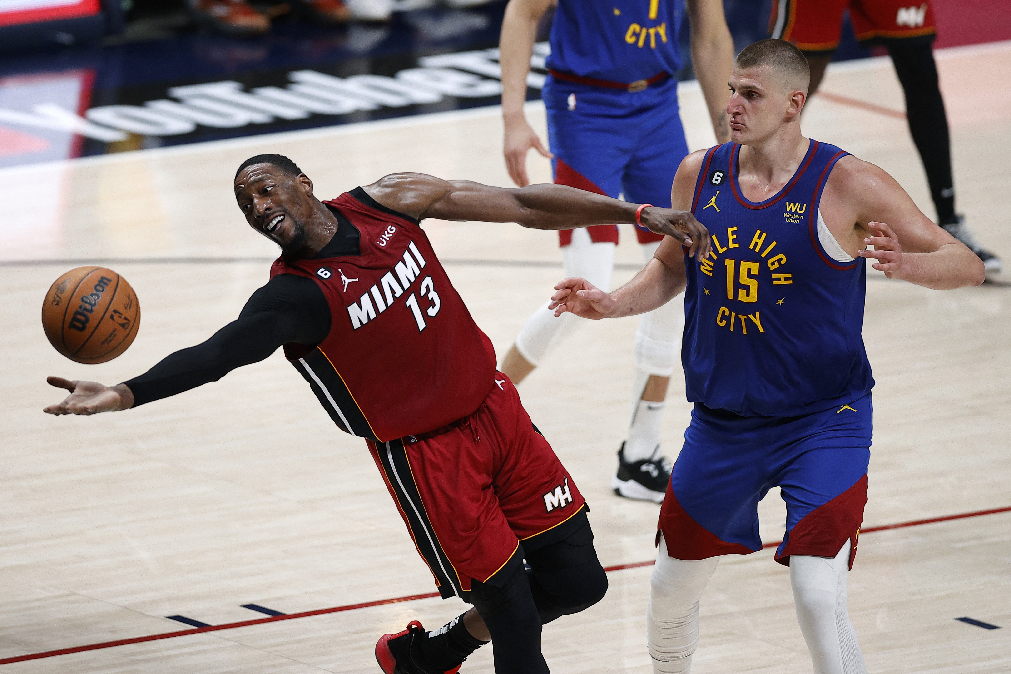 Jun 1, 2023; Denver, CO, USA; Miami Heat center Bam Adebayo (13) reaches for the ball as Denver Nuggets center Nikola Jokic