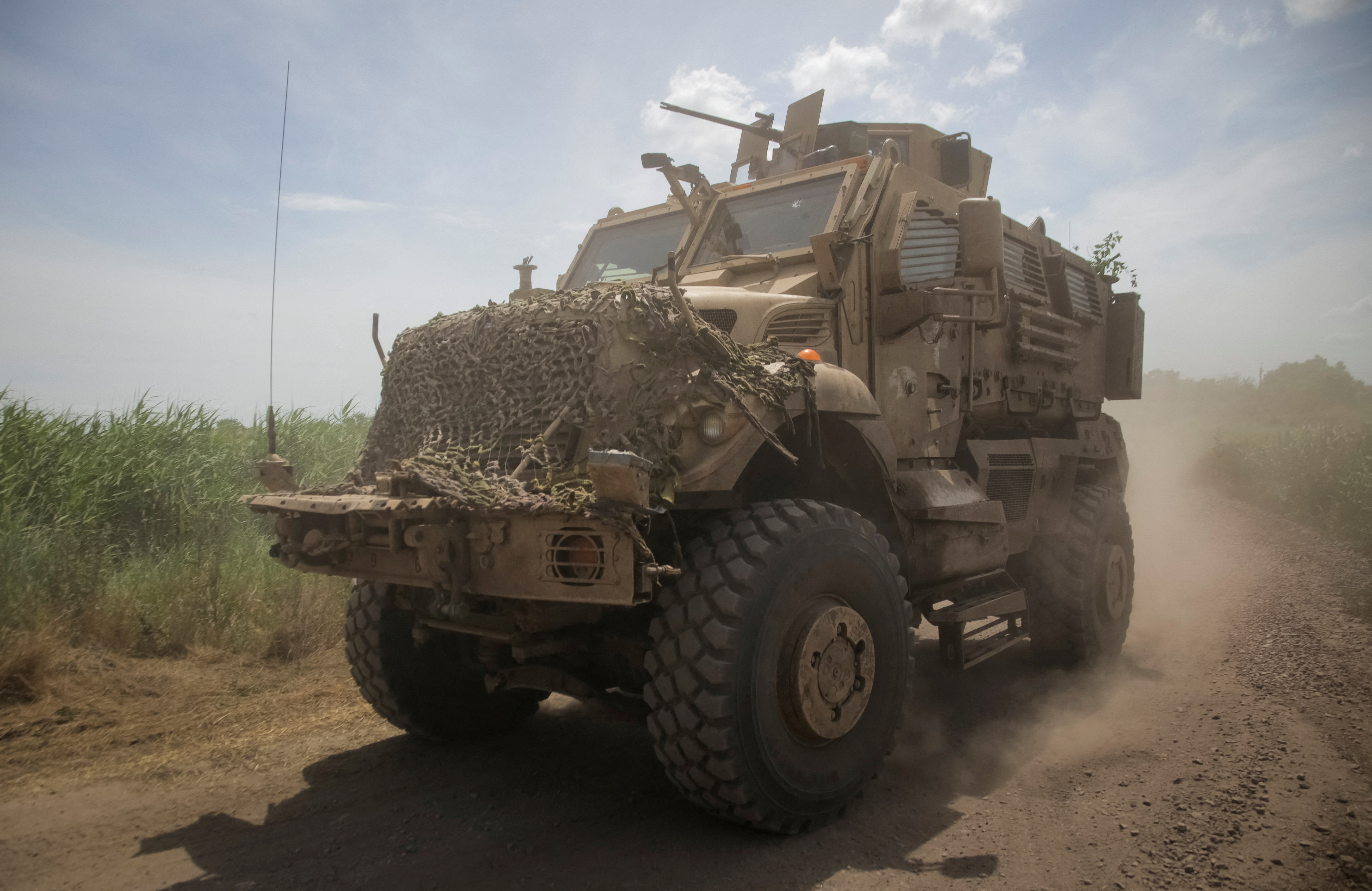 Ukrainian service members ride a military vehicle, amid Russia's attack on Ukraine, near the front line near the newly liberated village Neskuchne in Donetsk region