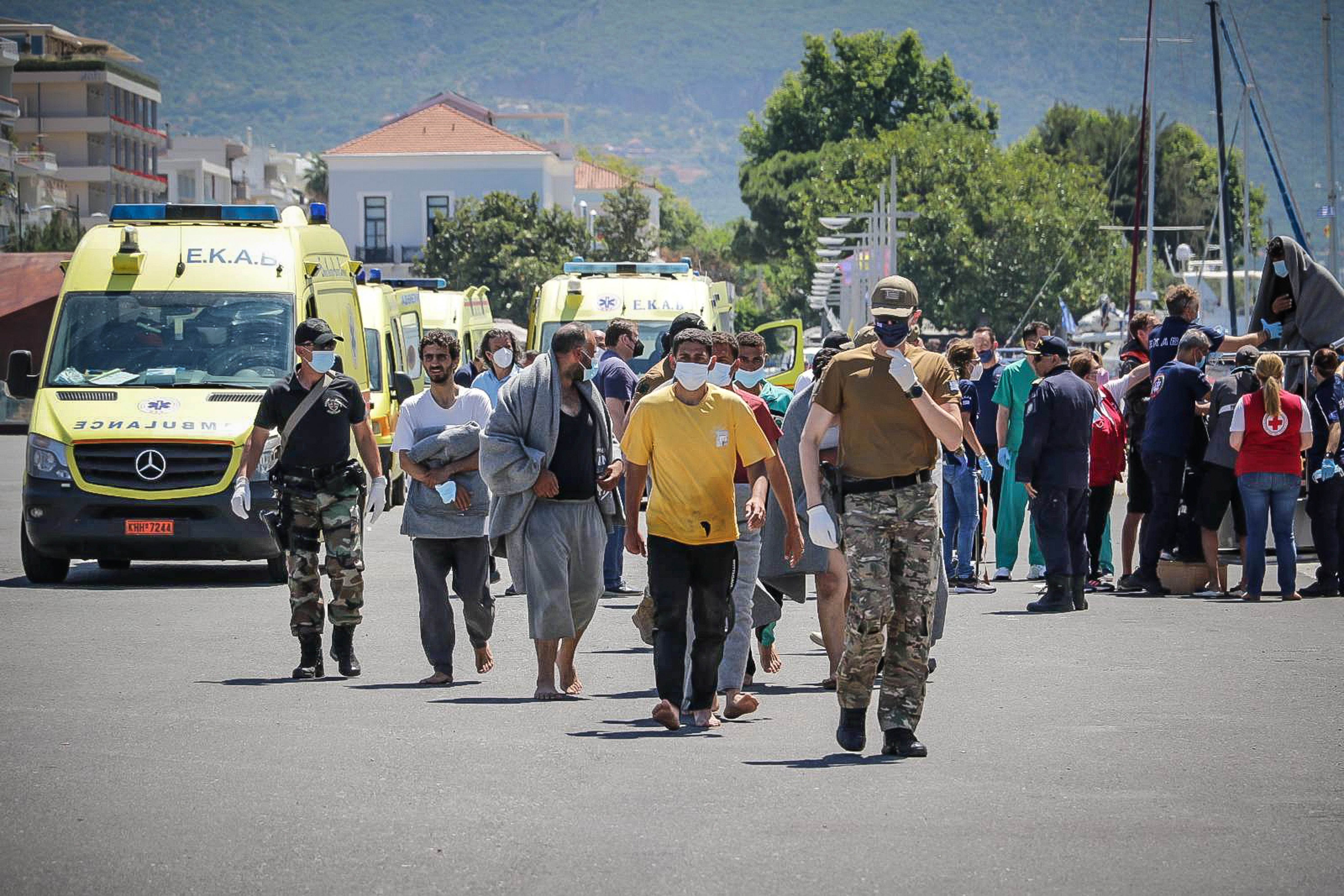 Migrants arrive at the port of Kalamata, following a rescue operation, after their boat capsized at open sea