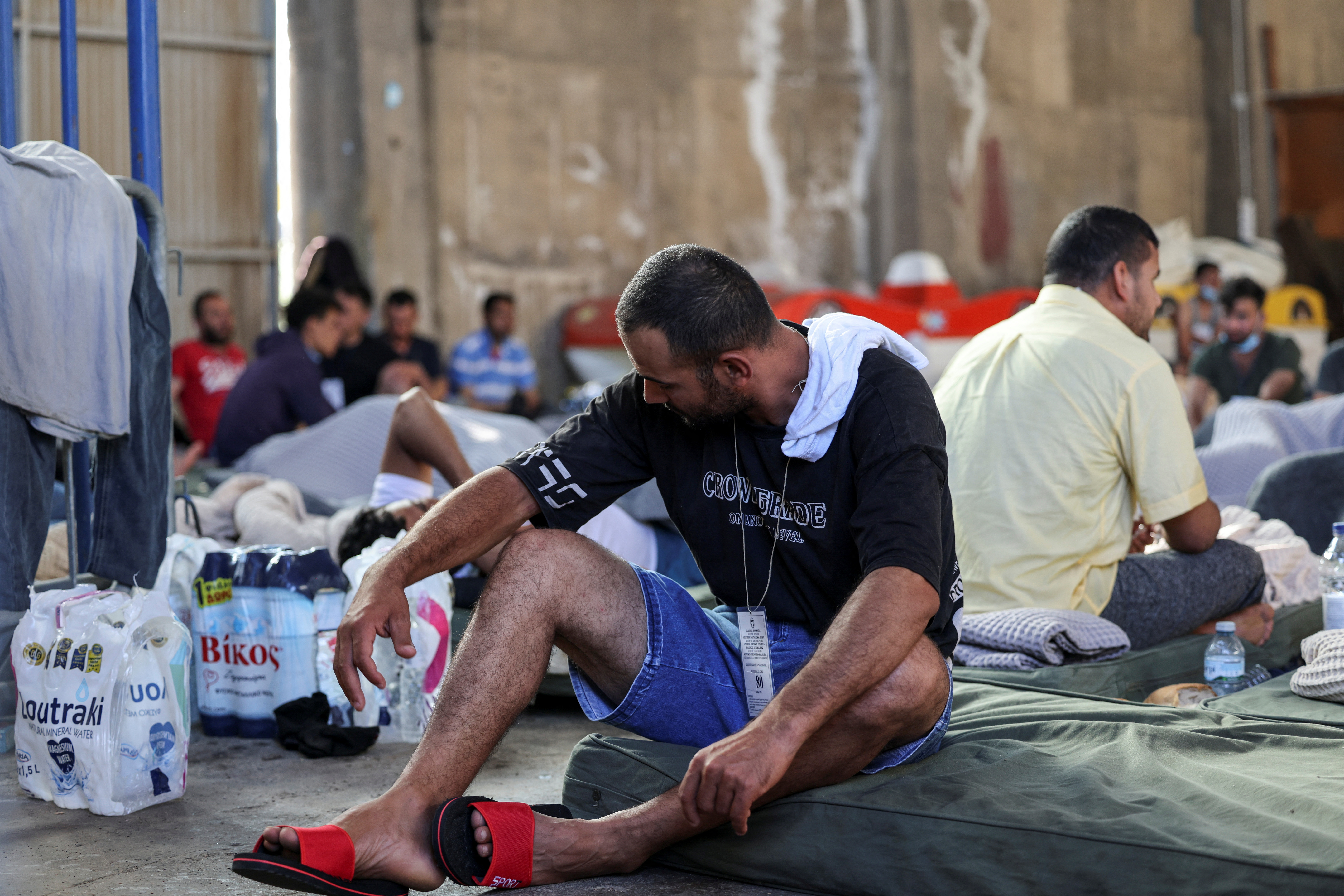 A migrant rests in a shelter,
