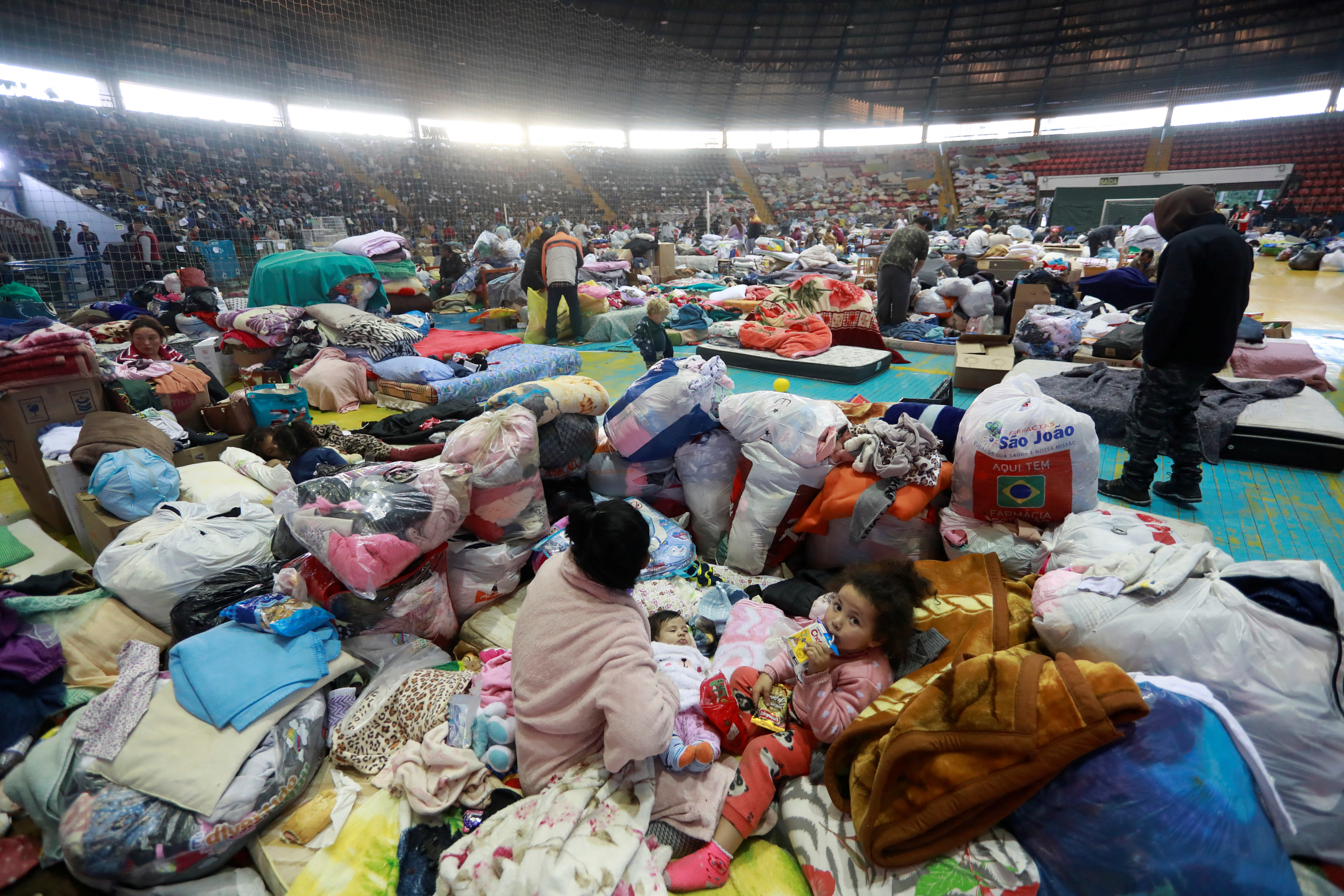 People affected by an extratropical cyclone rest in a gymnasium used as a shelter for flood victims in Sao Leopoldo