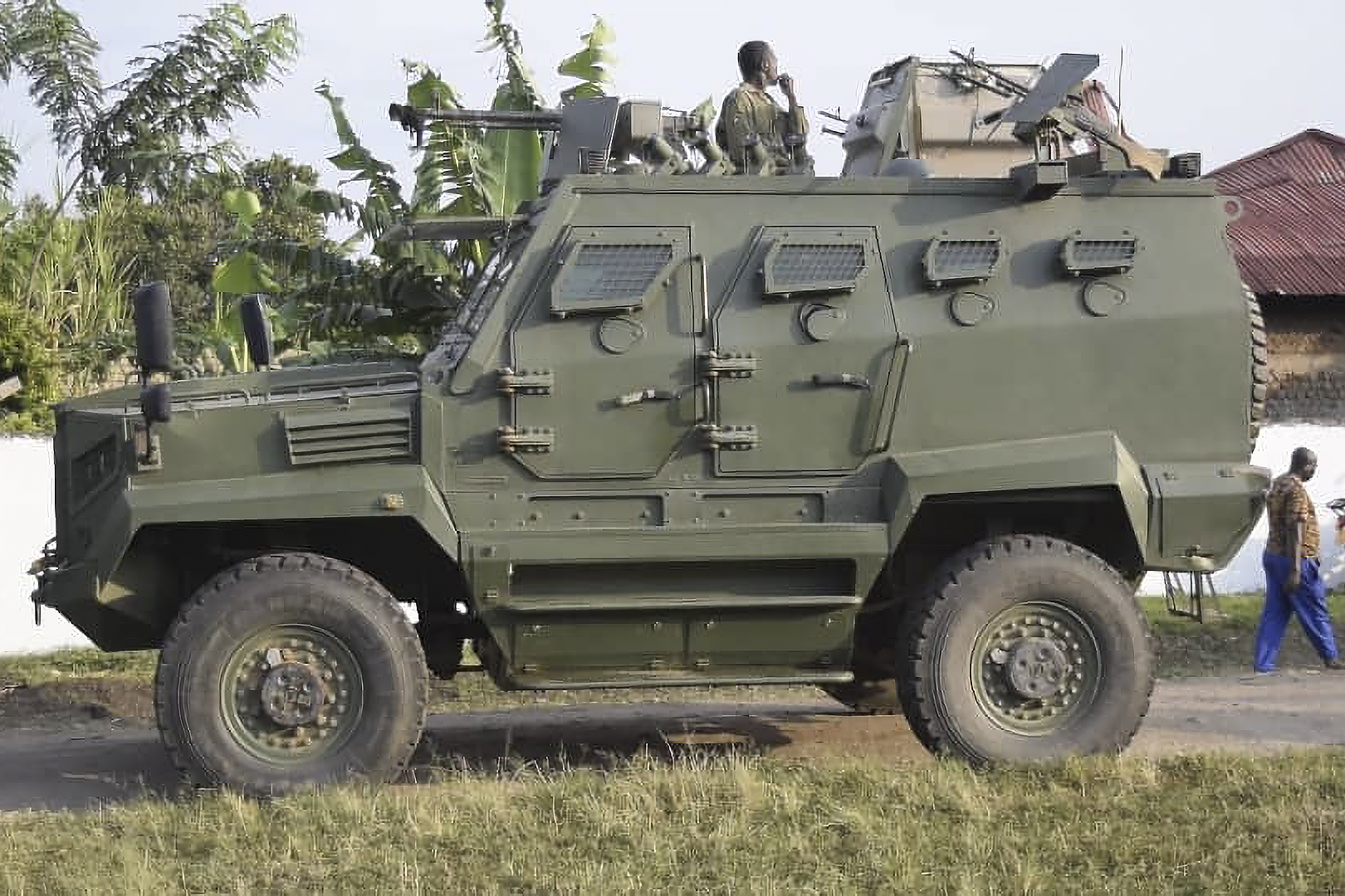 A Uganda People's Defence Force (UPDF) armored personnel carrier is seen outside the premises of an attack in Mpondwe,