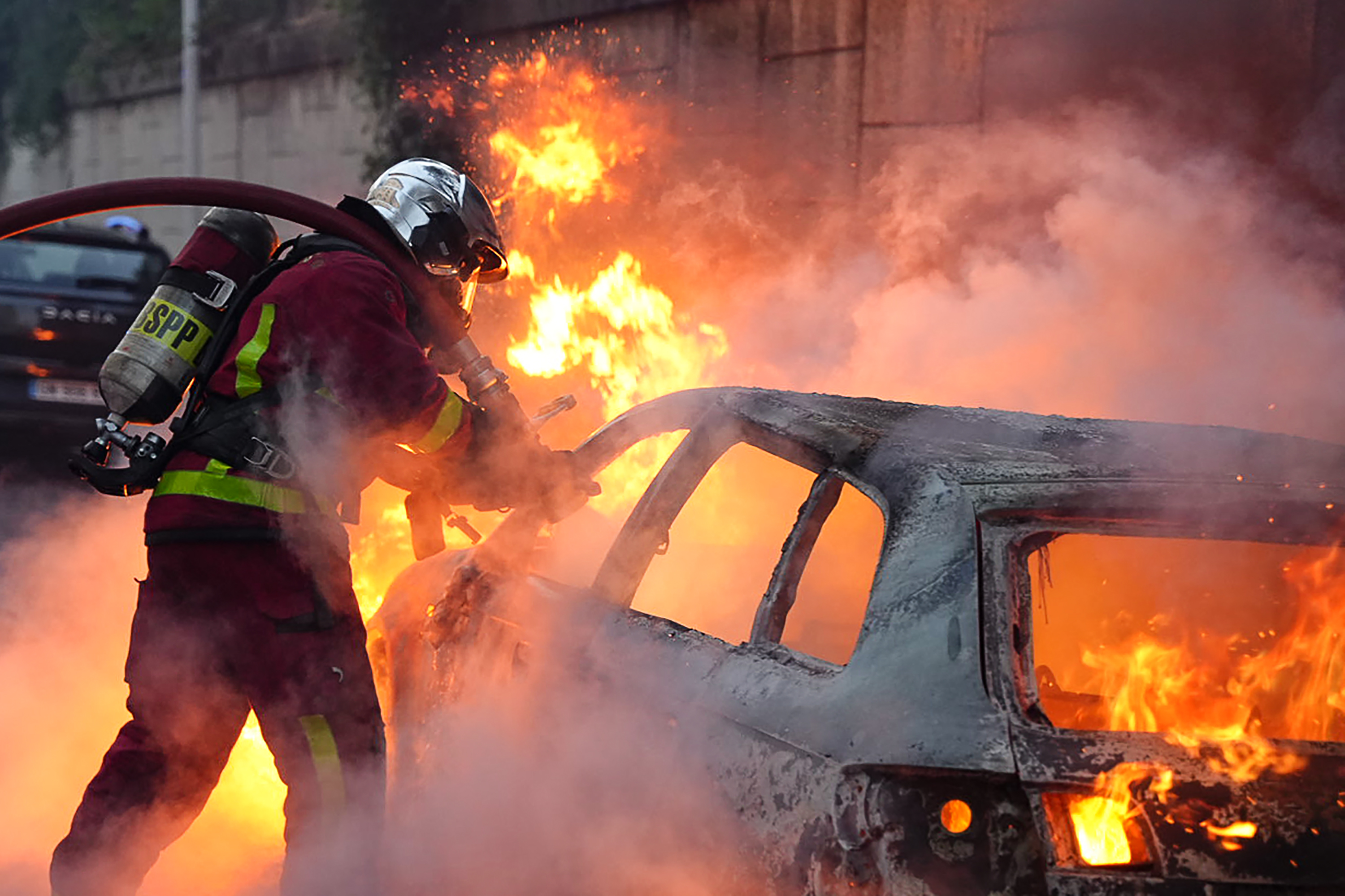 A vehicle burns, destroyed by protesters in Nanterre, west of Paris