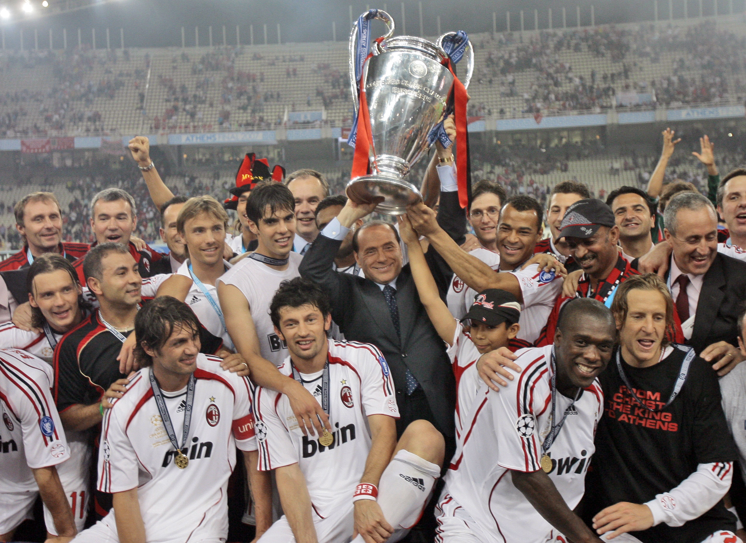 AC Milan's Silvio Berlusconi raises Champions League trophy aloft with the team
