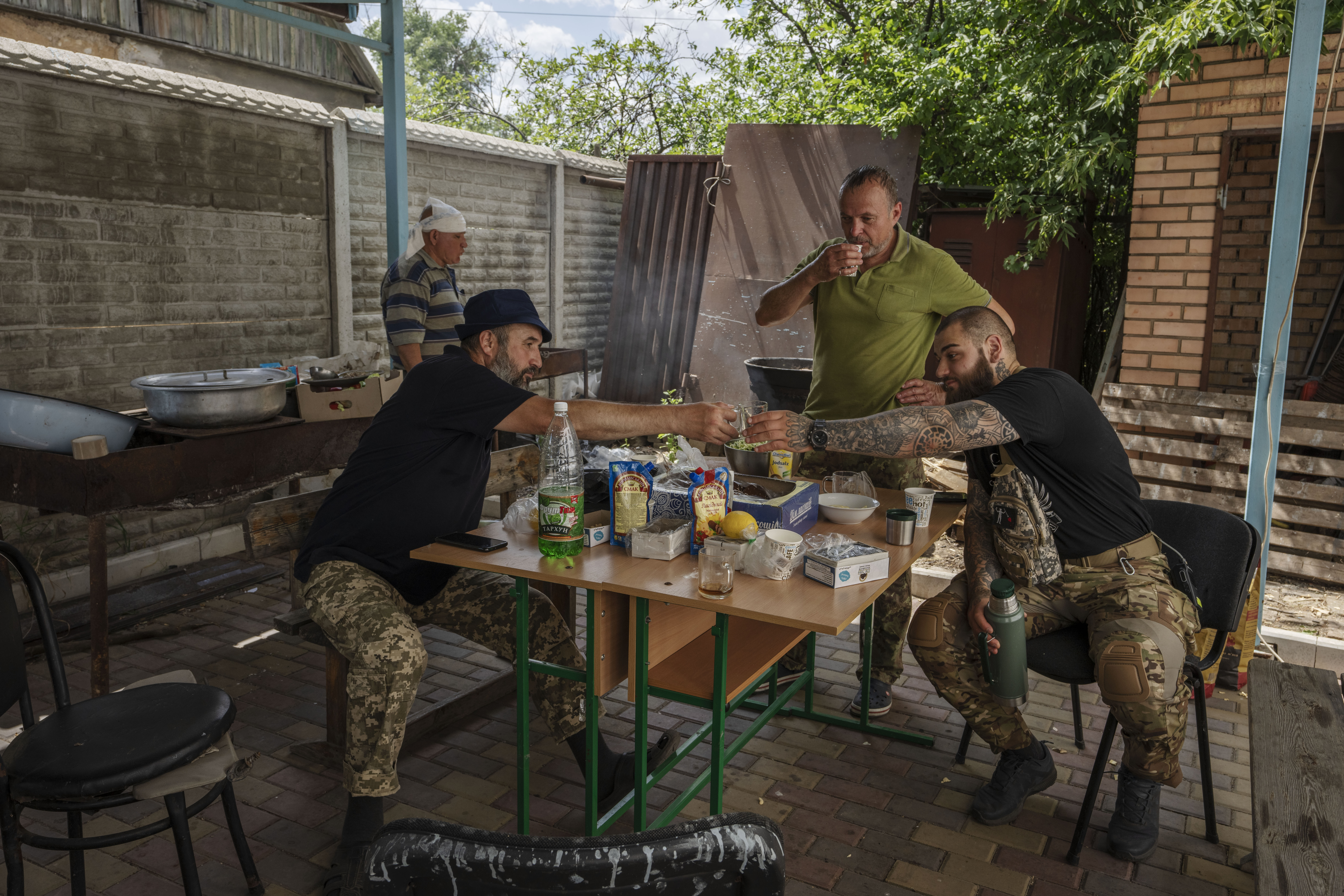 Muslim Ukrainian soldiers eat and drink after, prayers on the first day of Eid al-Adha, in Medina Mosque, Konstantinovka, eastern Ukraine, Saturday, July 9, 2022 