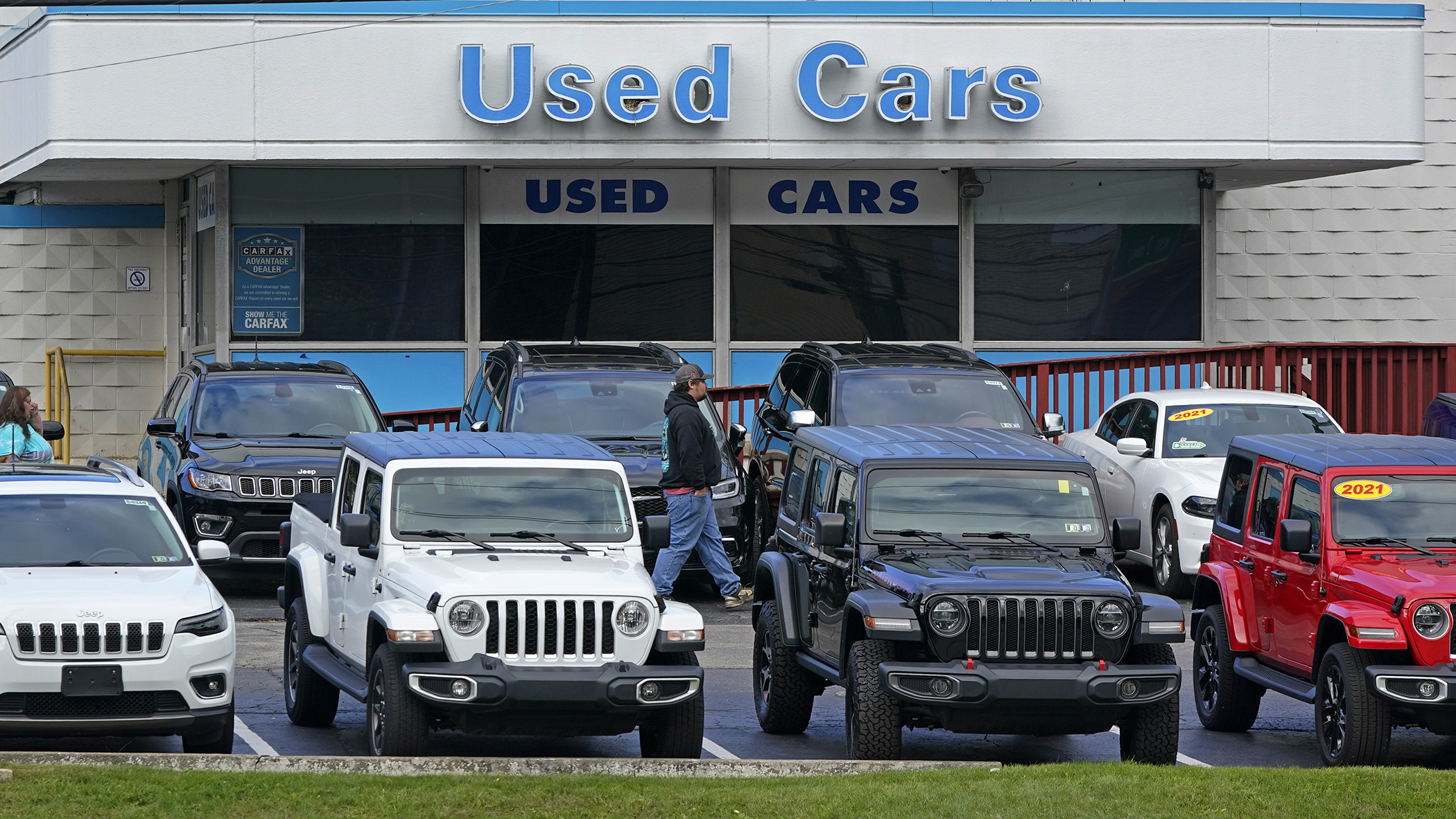A man walks through a used car lot in Pittsburgh