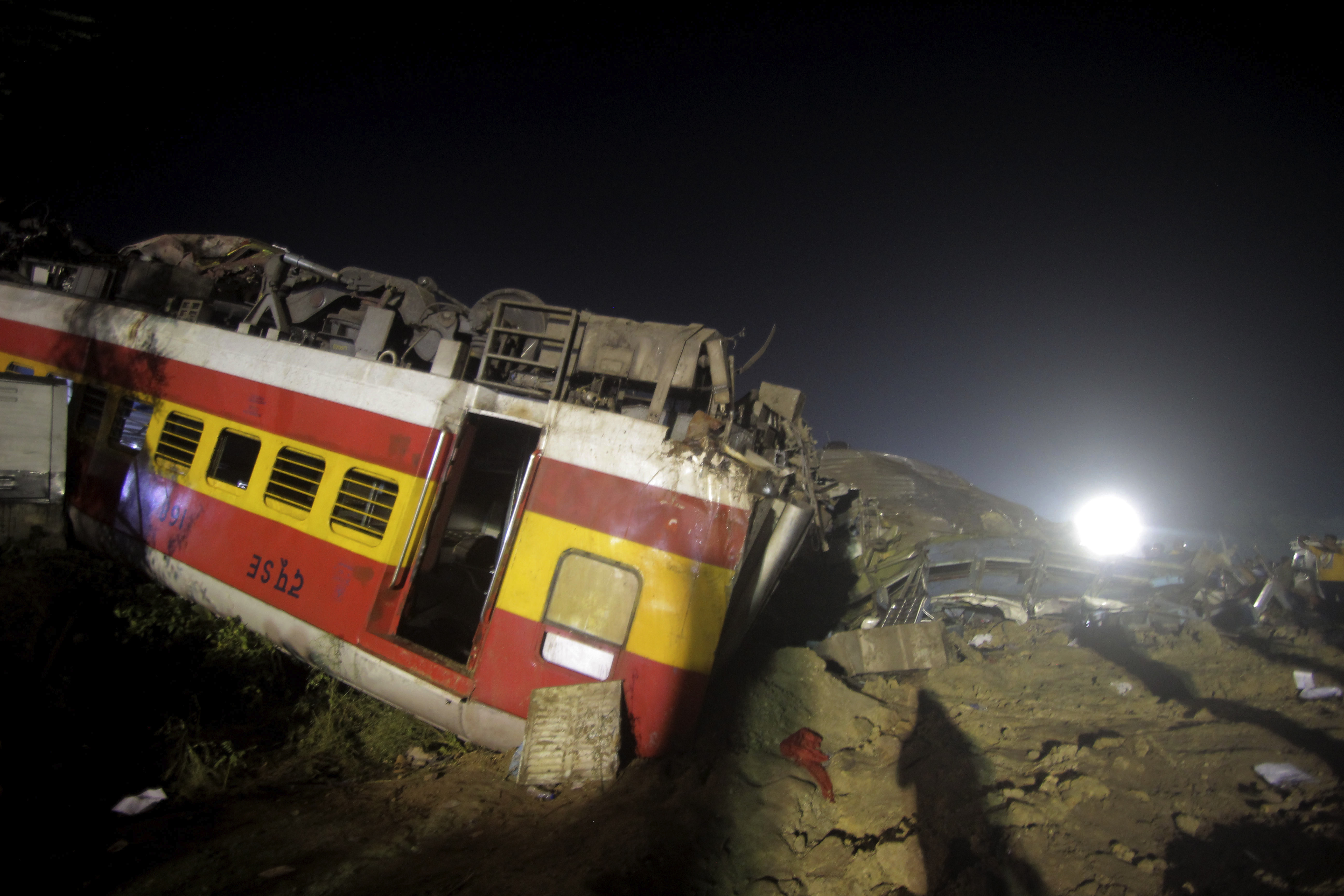 Rescuers work at the site of passenger trains accident in Balasore district