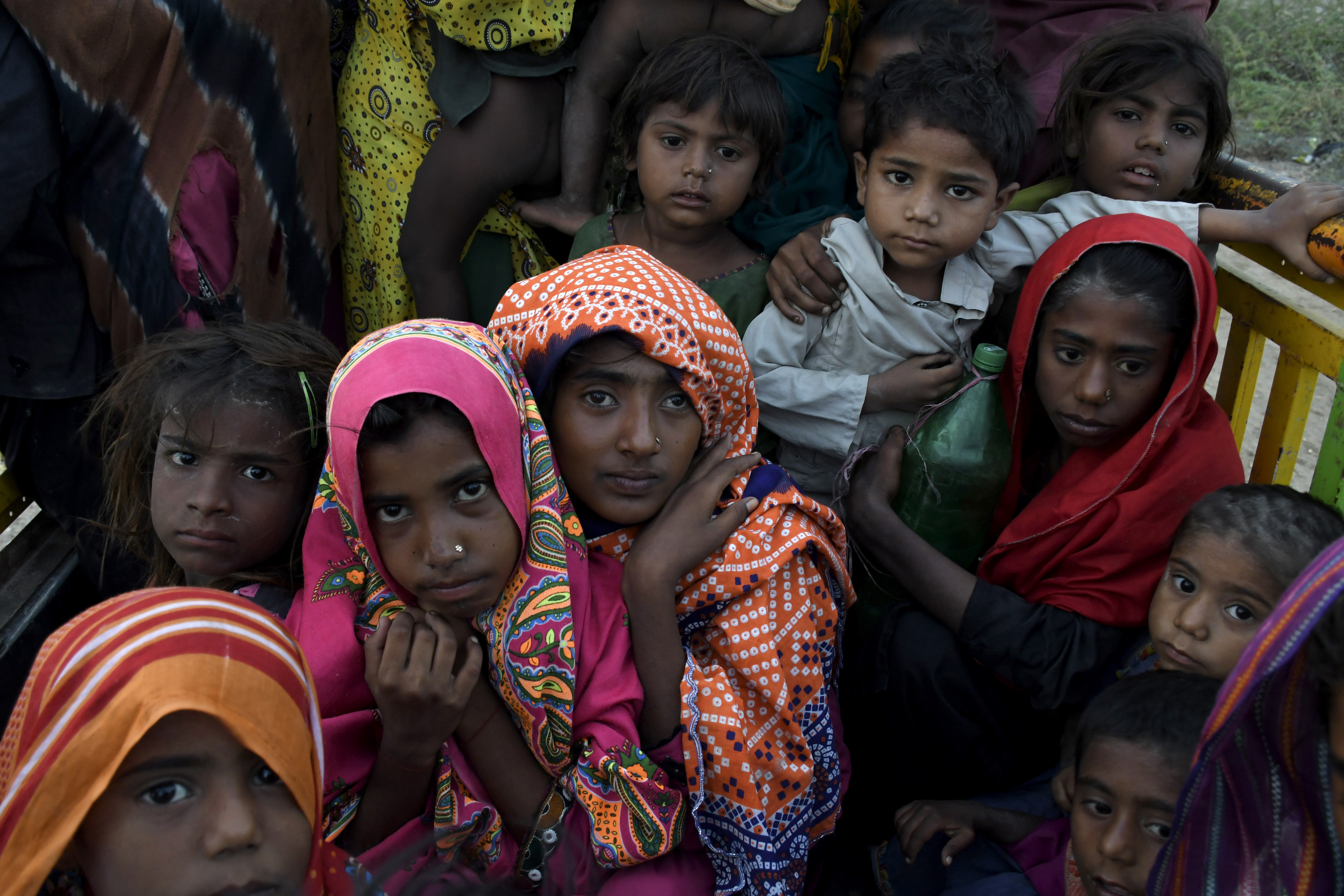 Children travel in a vehicle as they evacuate the area due to Cyclone Biparjoy approaching, at a coastal area Golarchi in Badin district