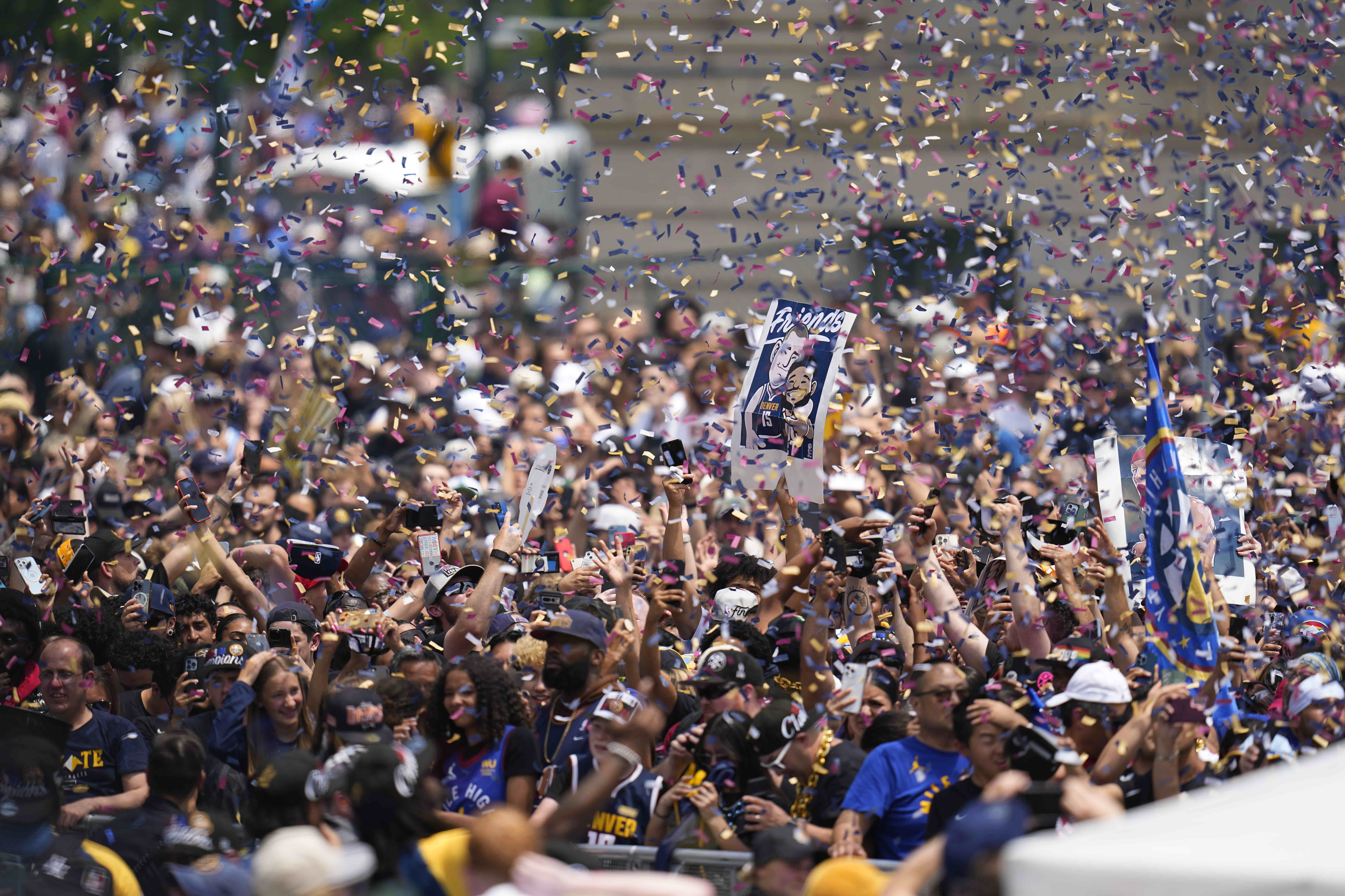 Confetti falls on the crowd during a rally to mark the Denver Nuggets first NBA basketball championship