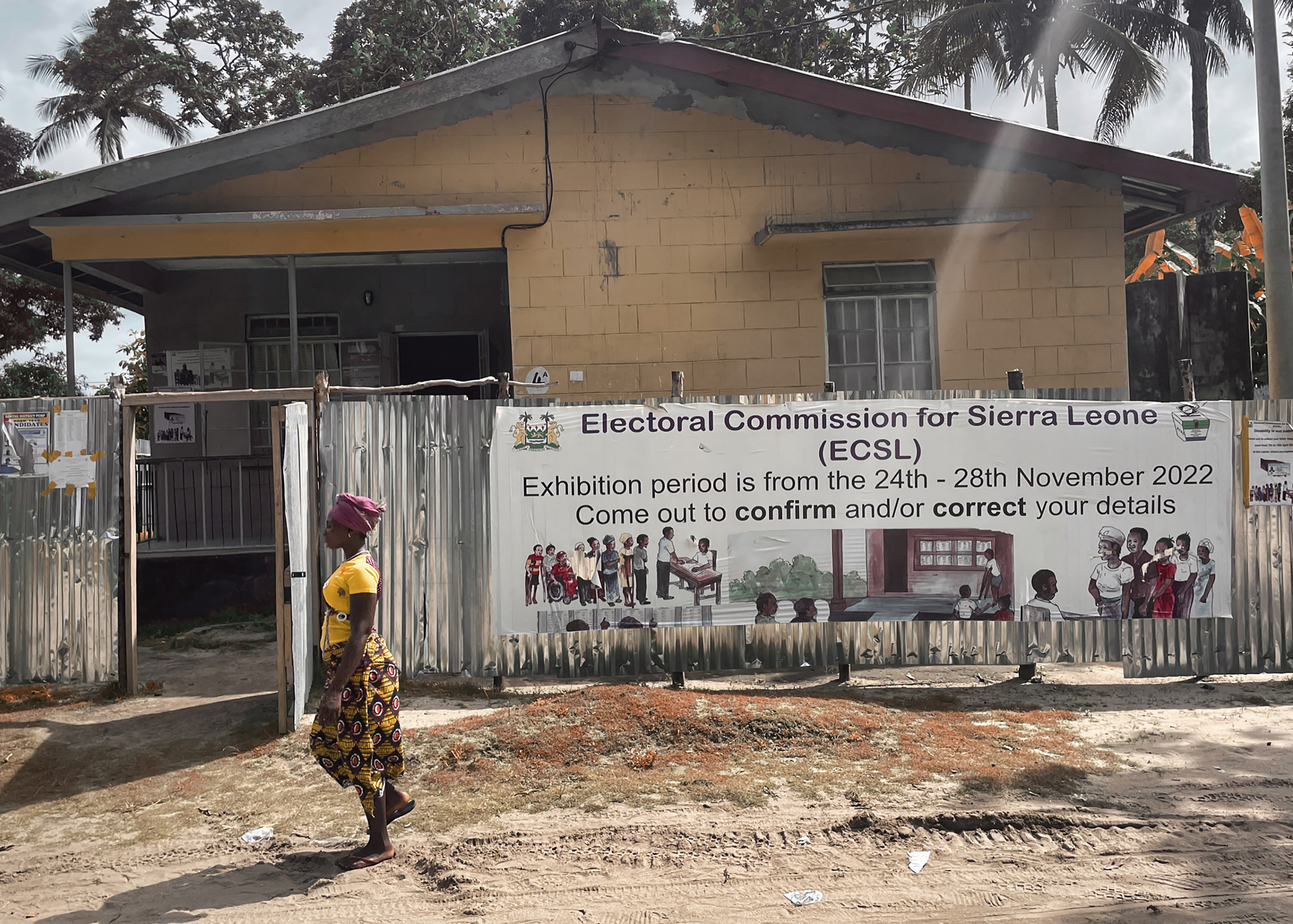 A woman walks past a polling station in Freetown, Sierra Leone
