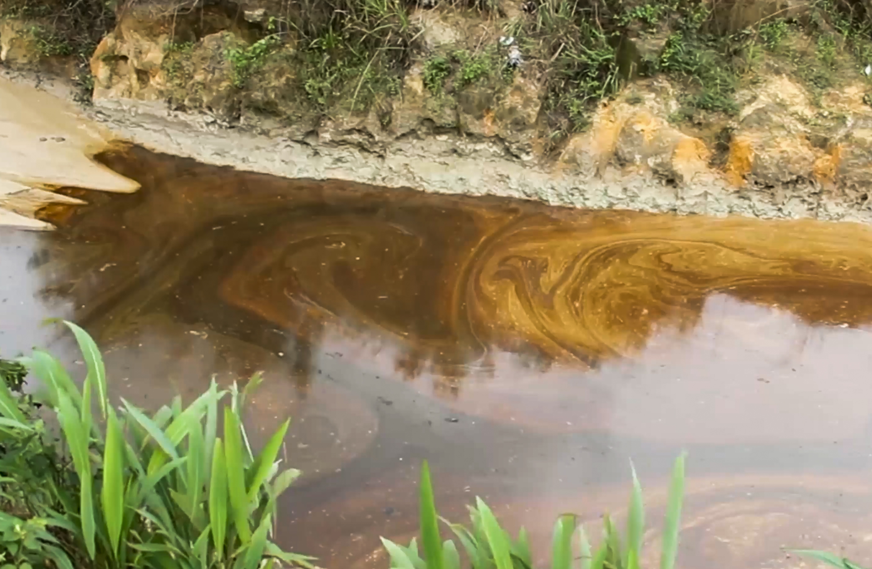 Oil from a spill pollutes the Okuku river in Ogoniland, Nigeria, June 16, 2023 (AP Photo)