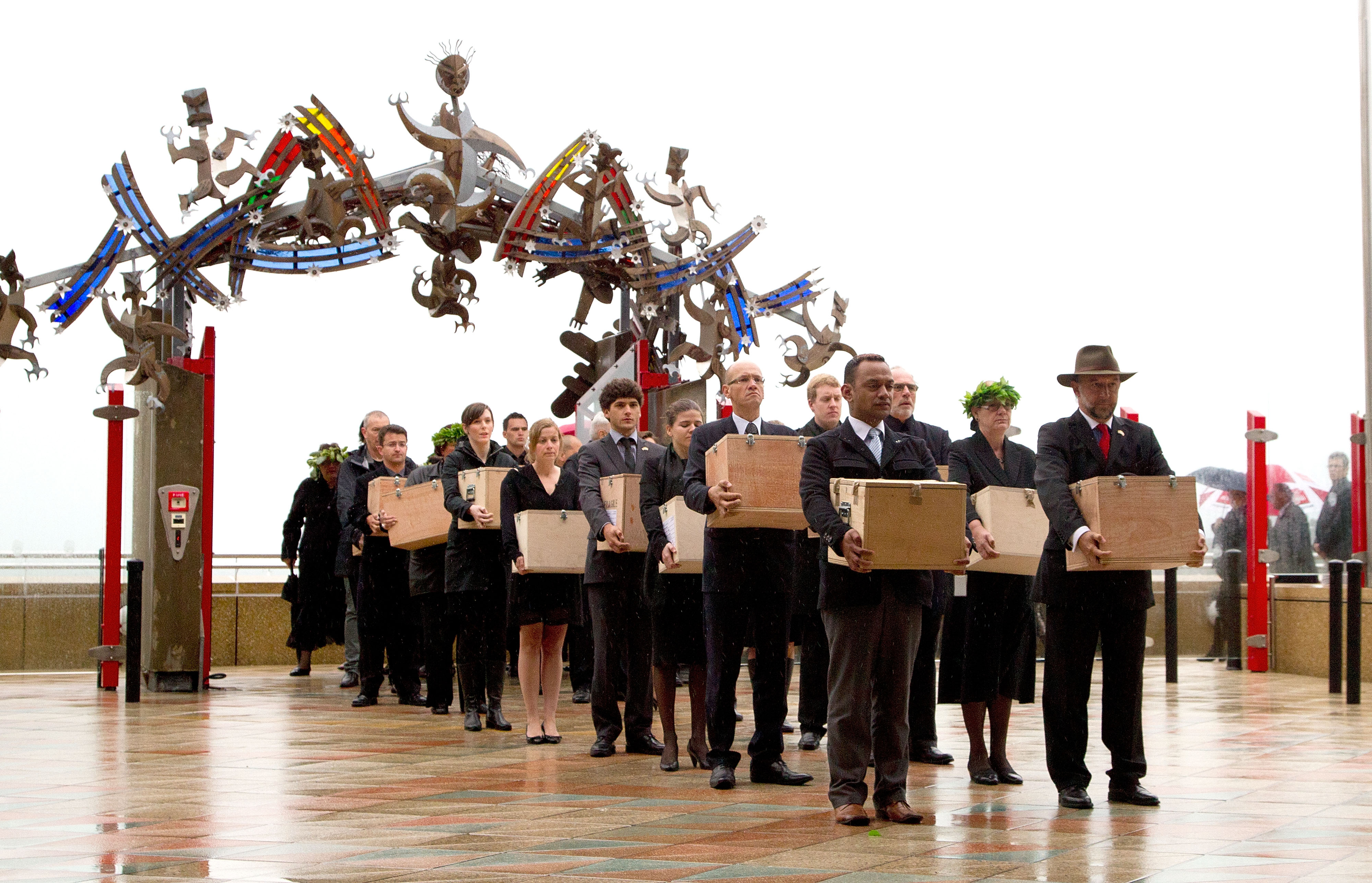 A Repatriation Team carry 20 Maori mummified tattooed heads (Toi Moko) that were taken to Europe in the 1700s and 1800s into the Marae during a Maori welcome ceremony at Te Papa Museum in Wellington on January 27, 2012. The tattooed heads were handed over by French officials at the Quai Branly Museum in Paris after a four-year political struggle. The Maori heads were once warriors that tattooed their faces with elaborate geometric designs to show their rank and were an object of fascination for European explorers who collected and traded them from the 18th century ownwards. AFP PHOTO / MARTY MELVILLE (Photo by Marty Melville / AFP)